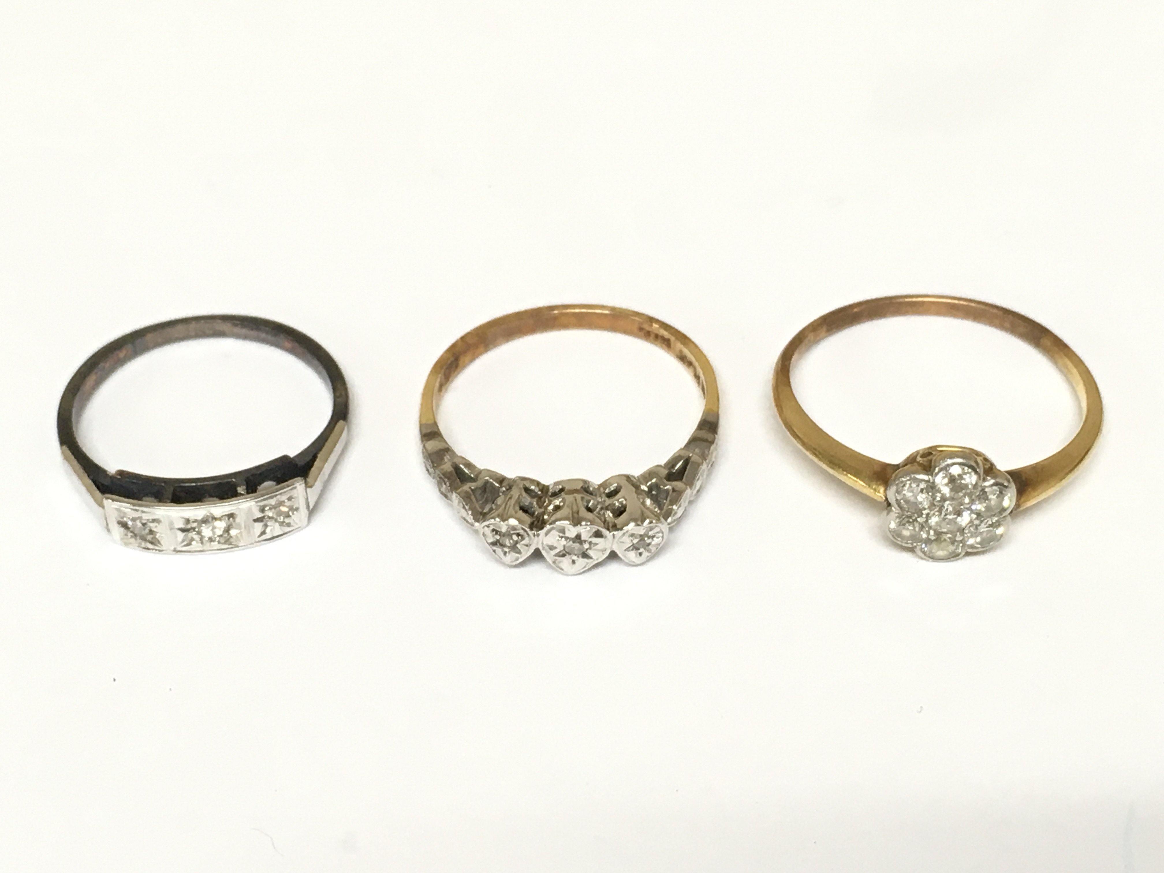 Three 18ct gold and platinum rings set with diamonds. 6g total