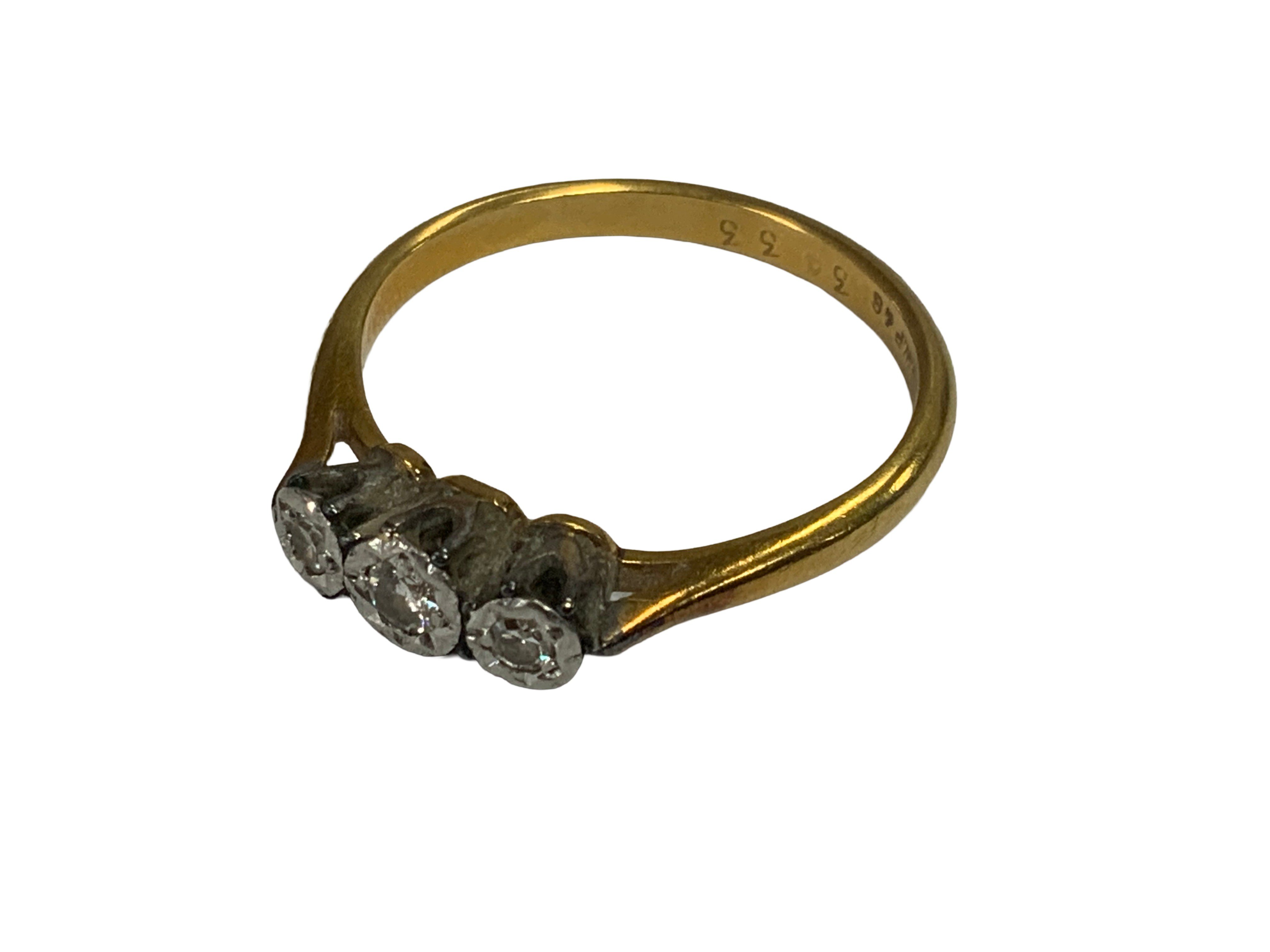 A 3 stone 18ct gold and platinum ring. Size P. (A)