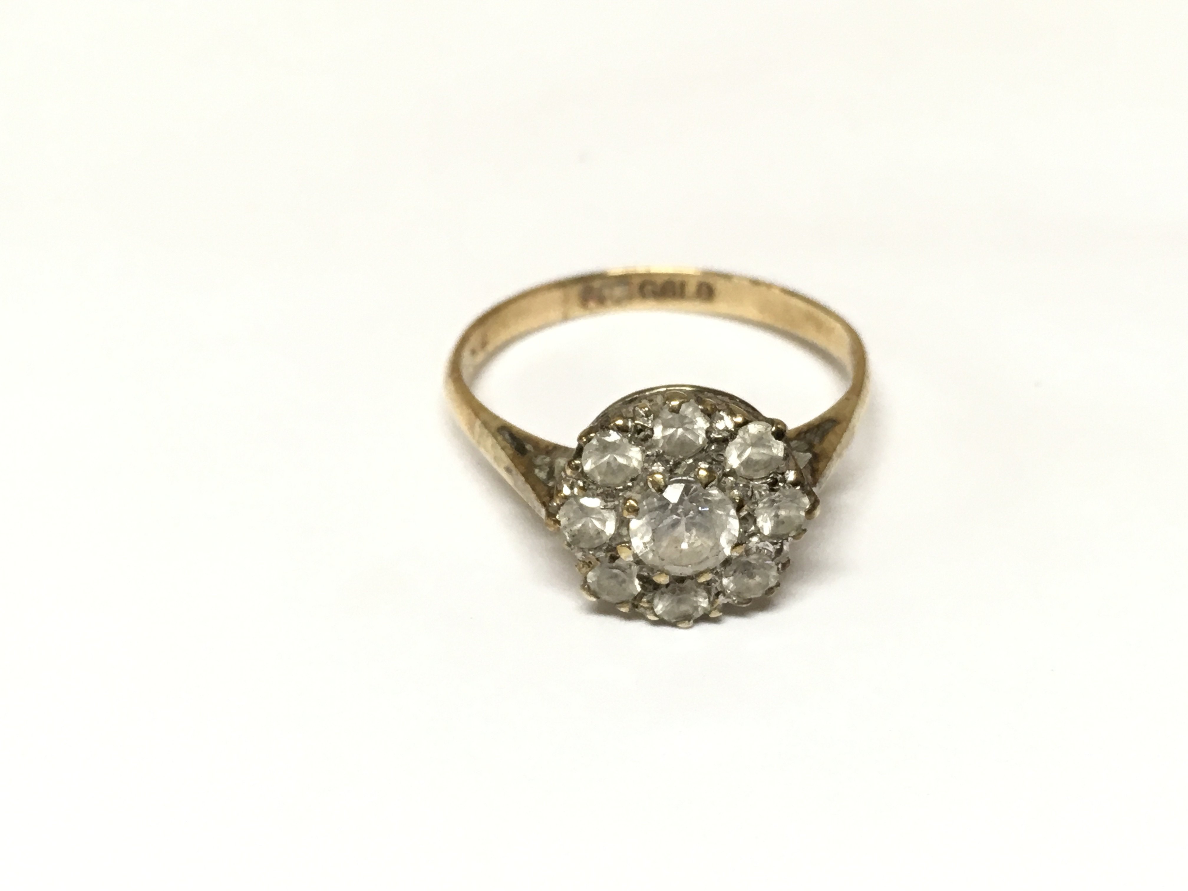 A 9ct gold ring set with white stones. 2.44g and P