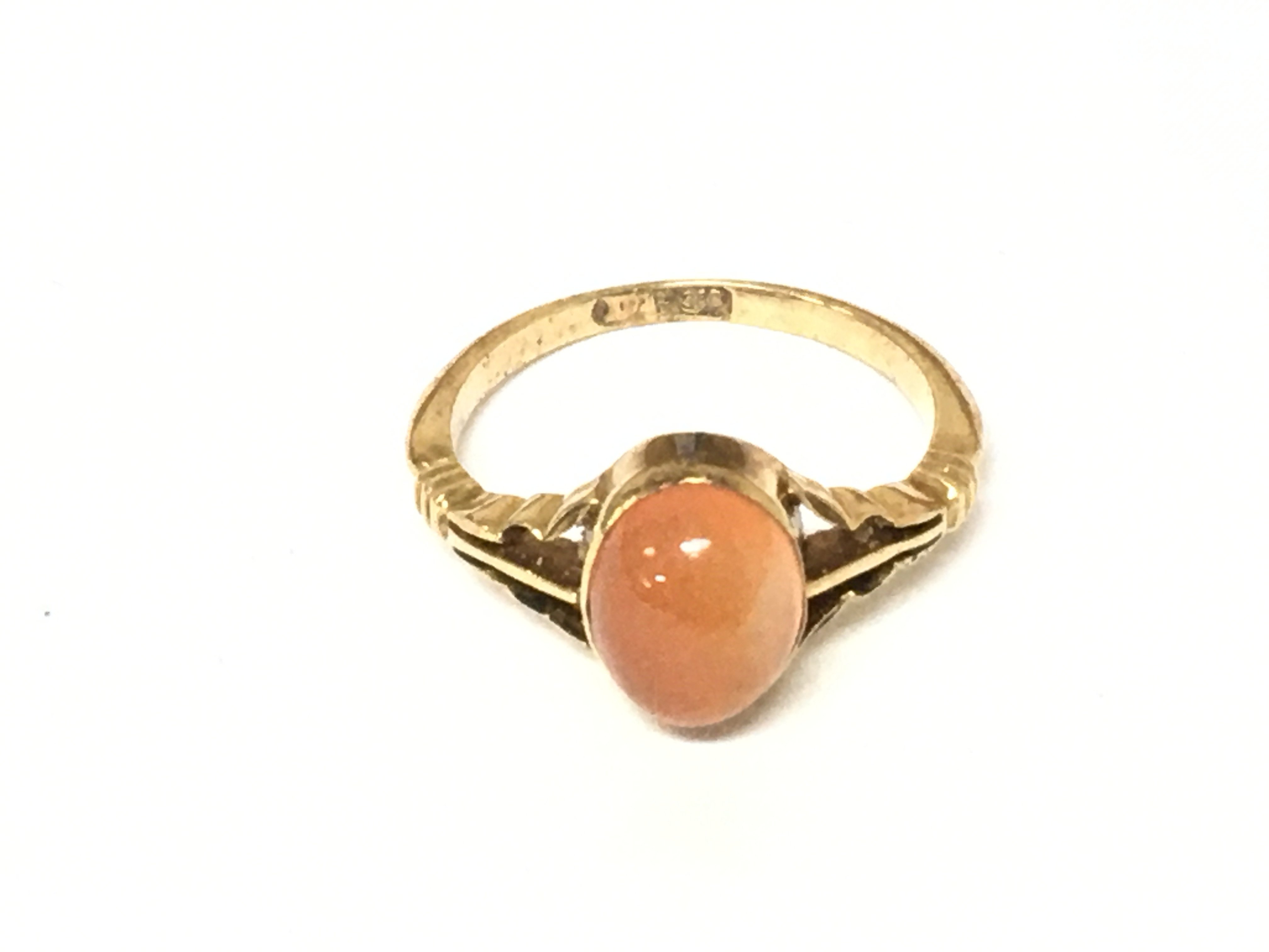 A gold ring set with orange opal. Size J 1/2 and 3g
