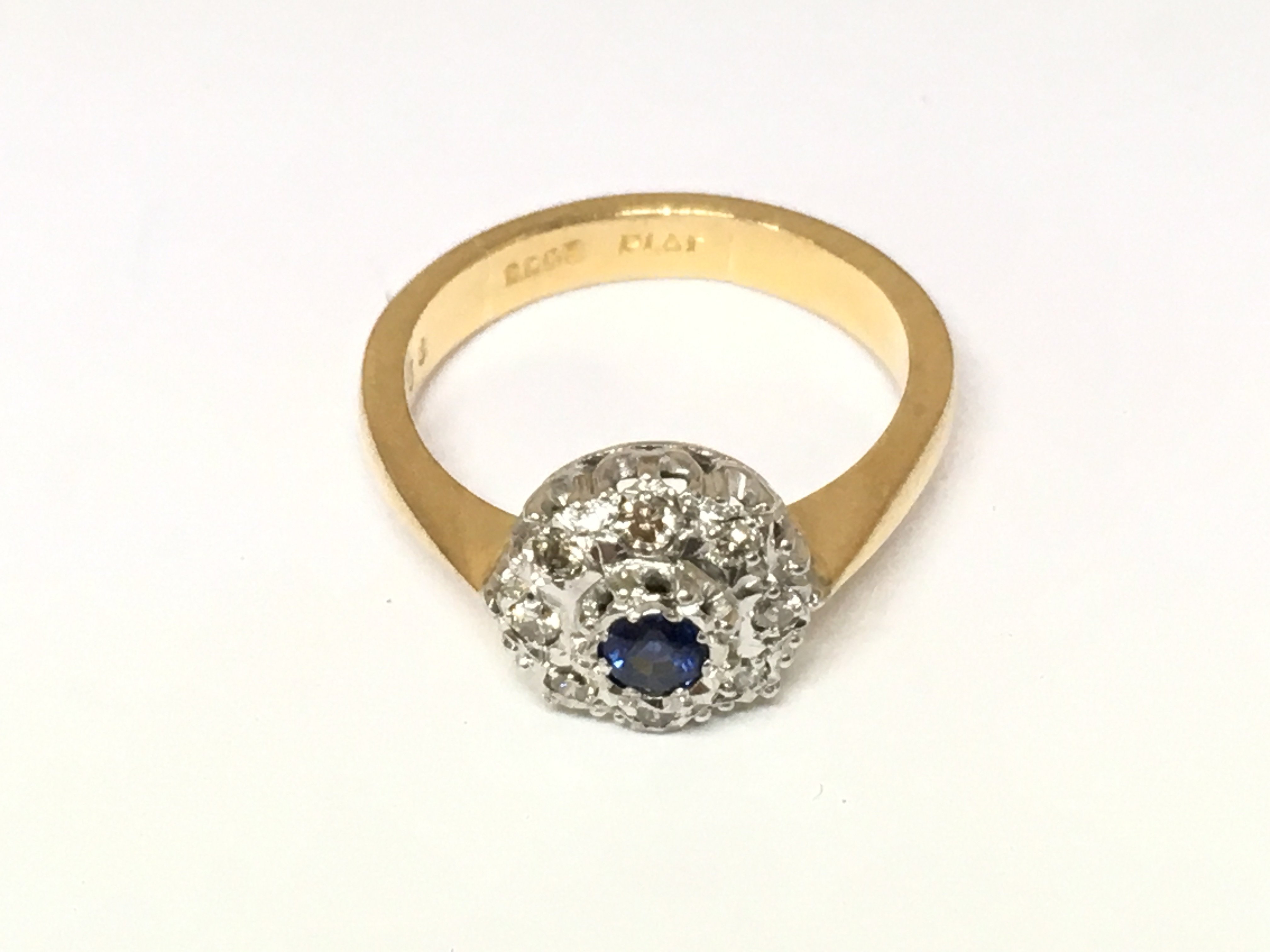 A 22ct gold ring set with sapphire and diamonds. Approx Size N and 6g