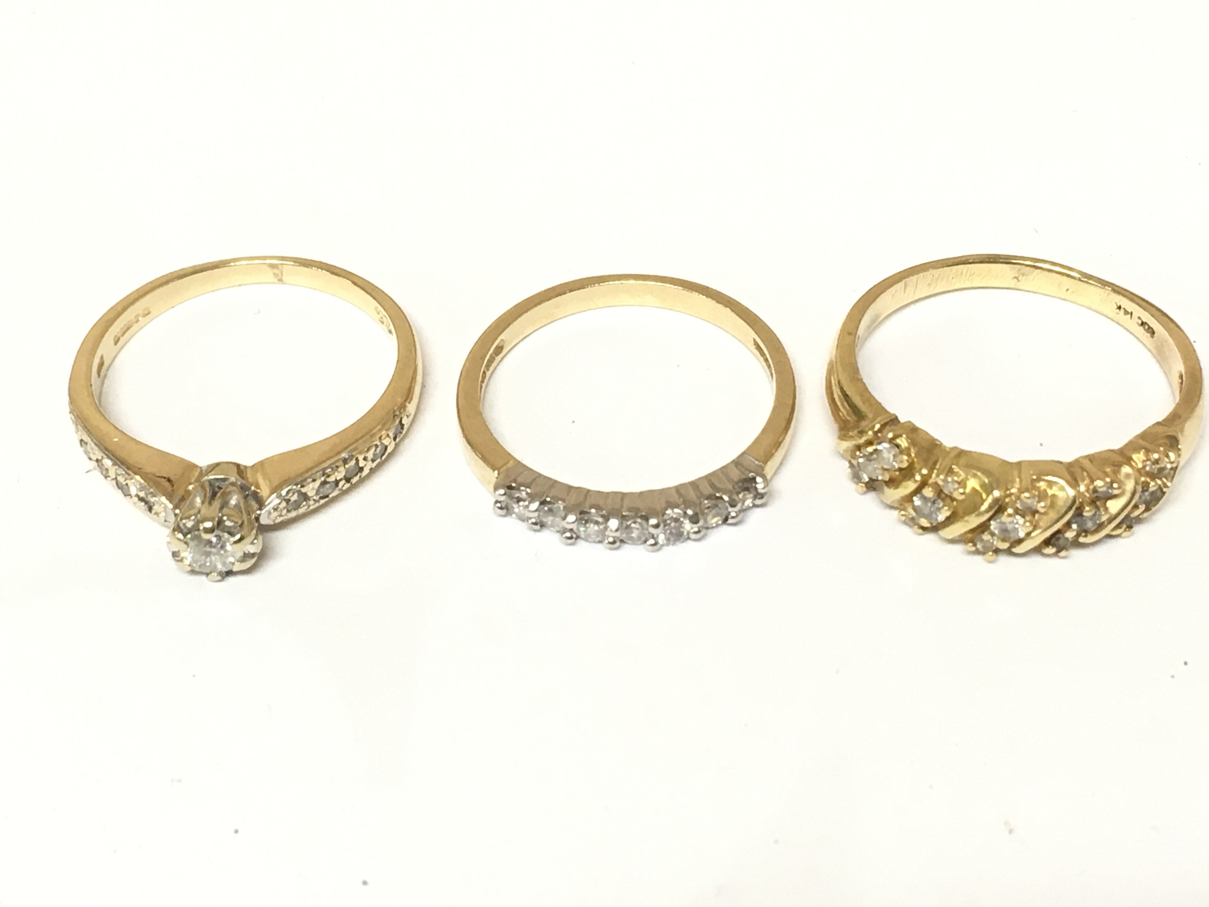 Three 14ct gold rings set with diamonds. Approximately 7.6g and sizes M M 1/2 and P Postage A
