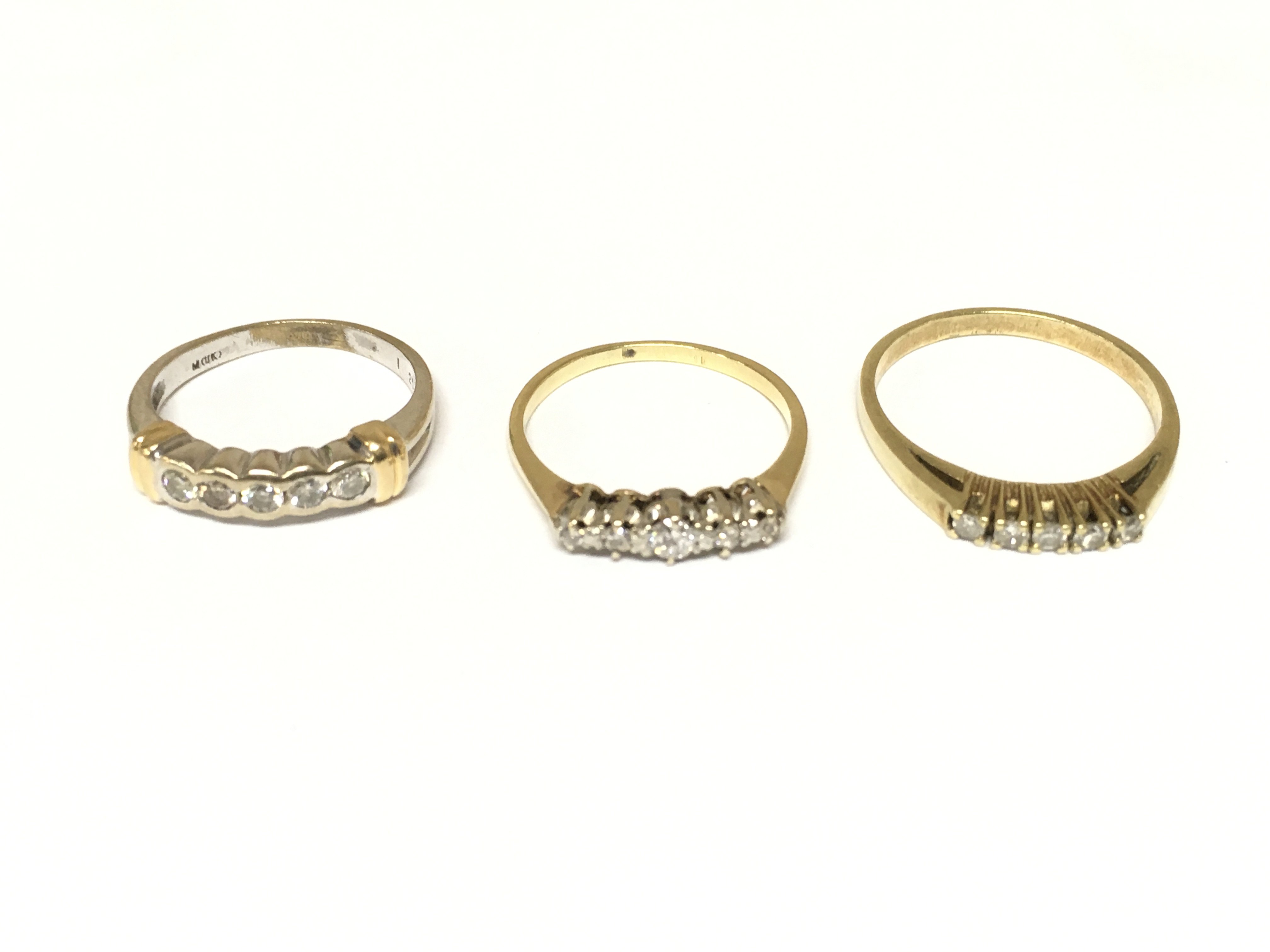 Three unmarked diamond 5 stone rings. Approximately 7.6g and sizes J K and O