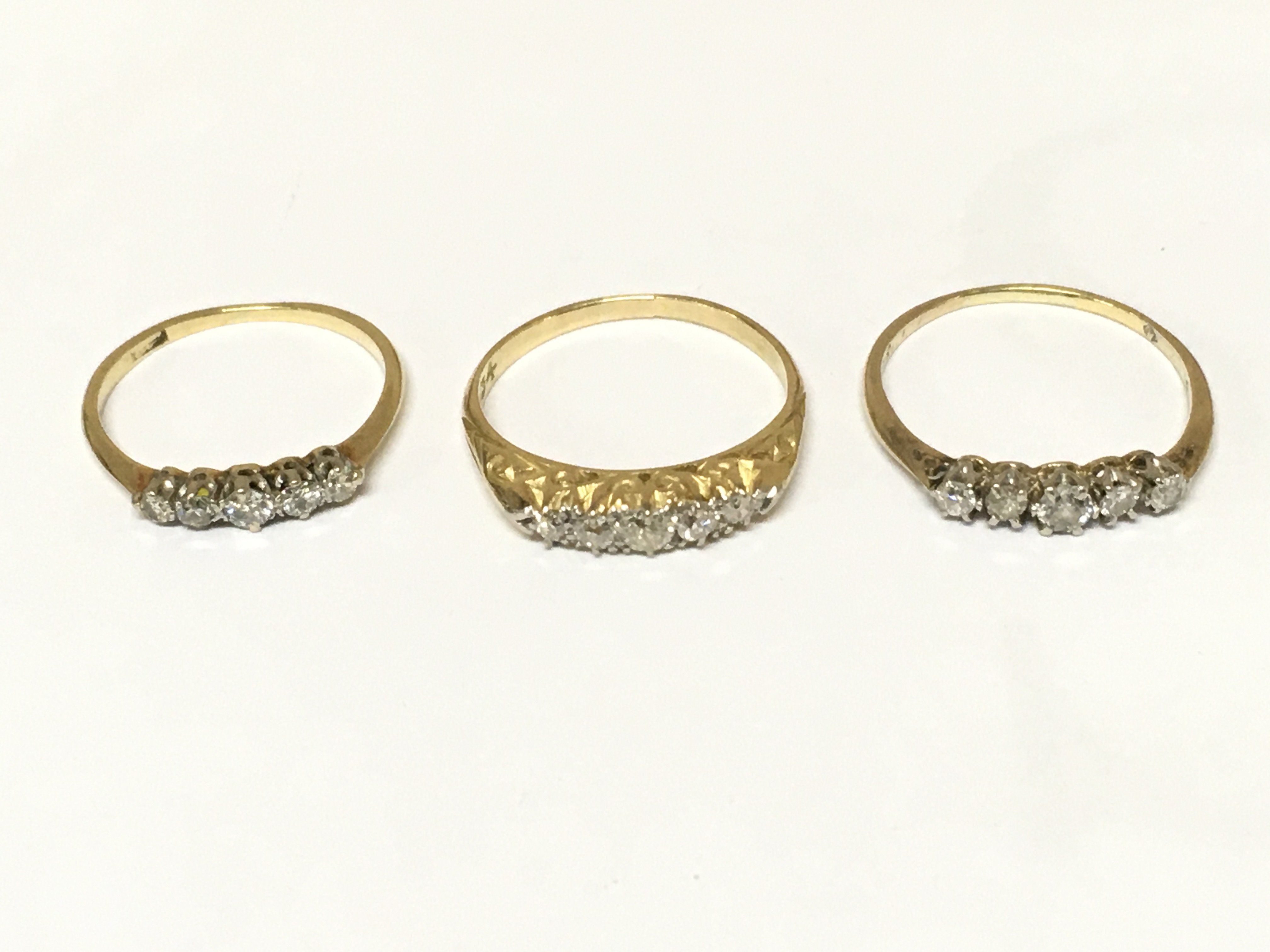 Three unmarked diamond 5 stone rings. Approximately 5.4g and sizes M M 1/2 and K