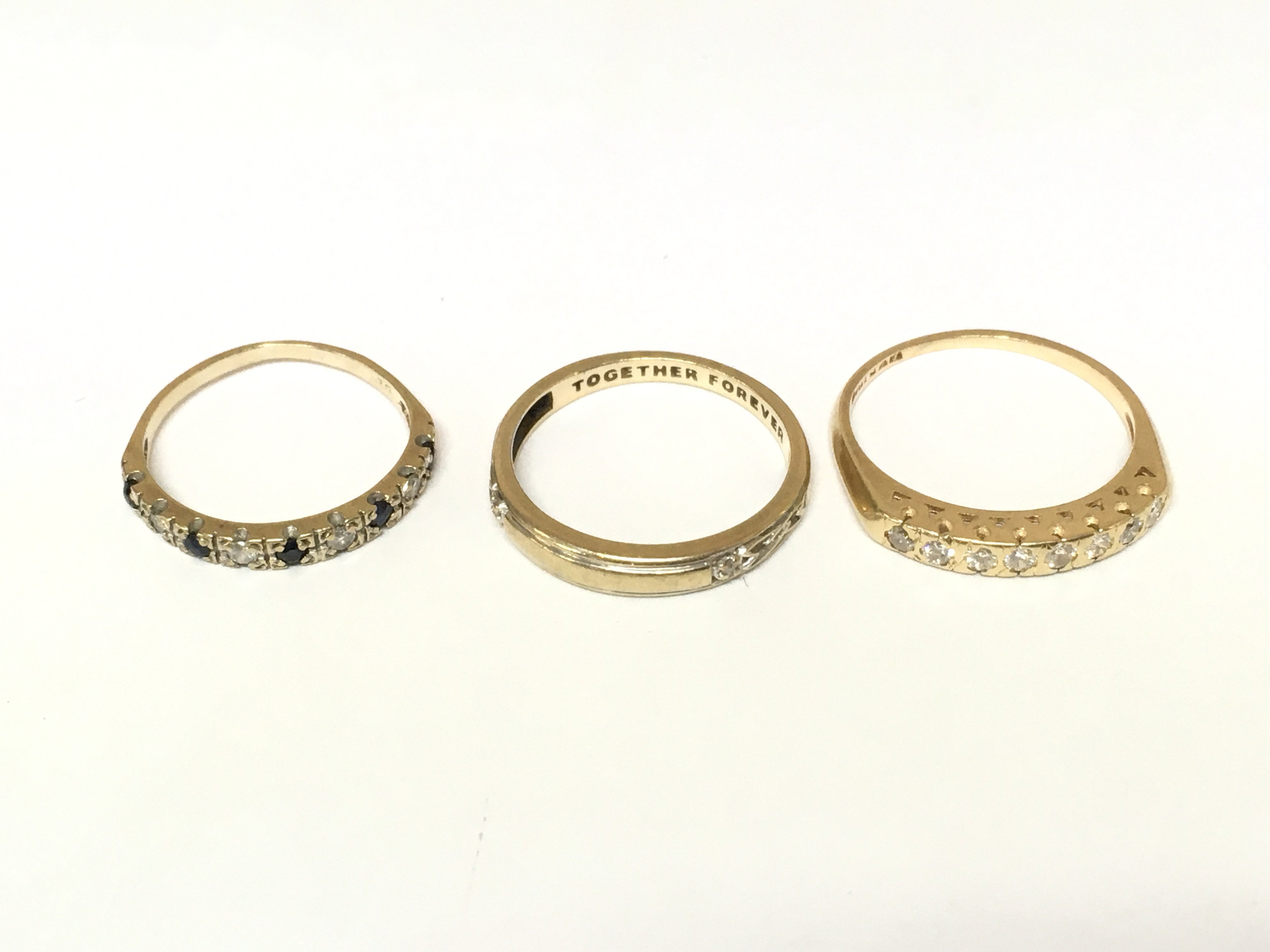 Three unmarked rings set with various gems. Approximately 6.3g and sizes M O and P