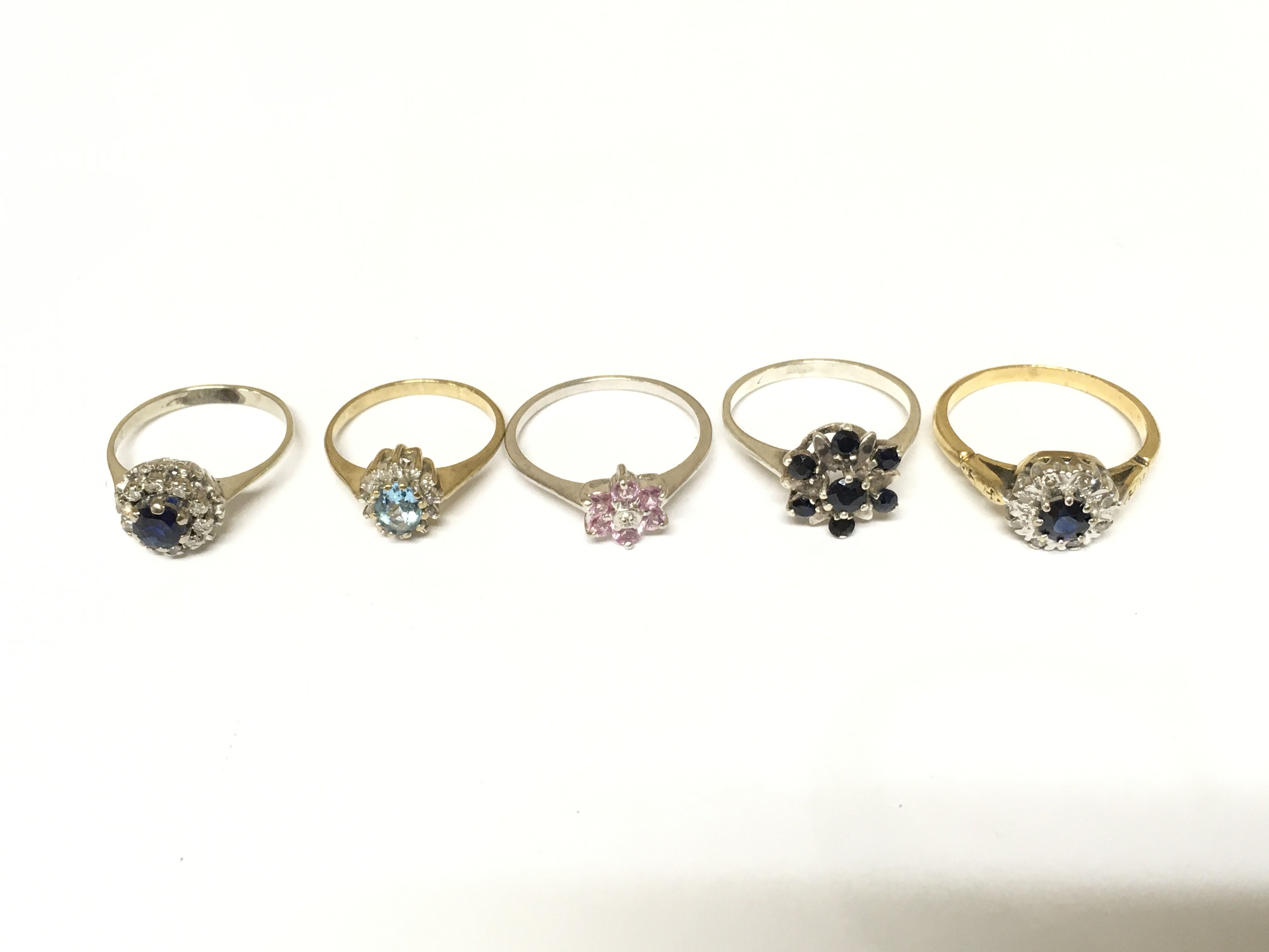 Five unmarked cluster rings set with various gems. Approximately 11.3g and sizes I L N O1/2