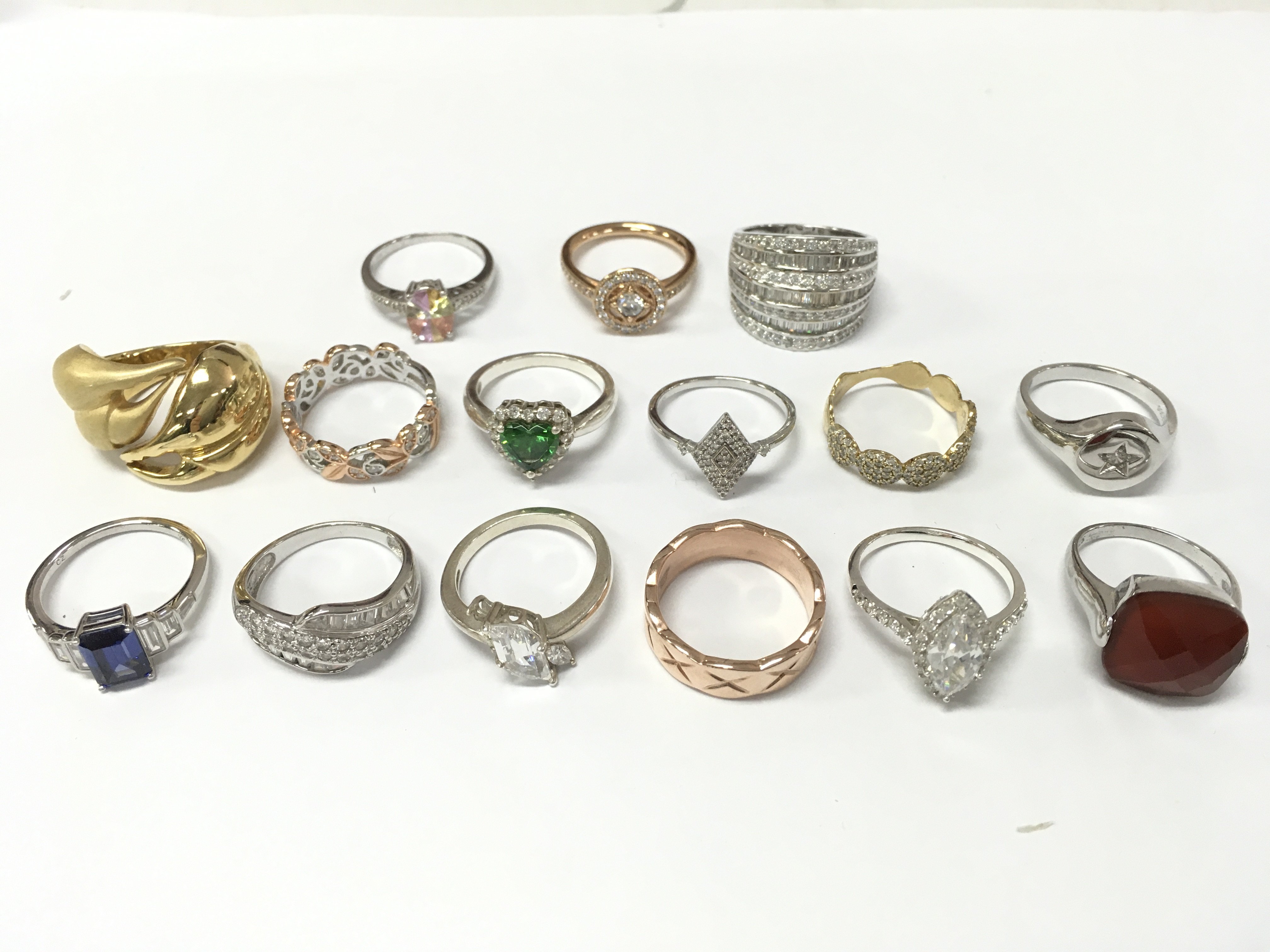 A Collection of silver and non silver rings set with CZ and other various gem stones. Sizes P and O etc . Postage category A