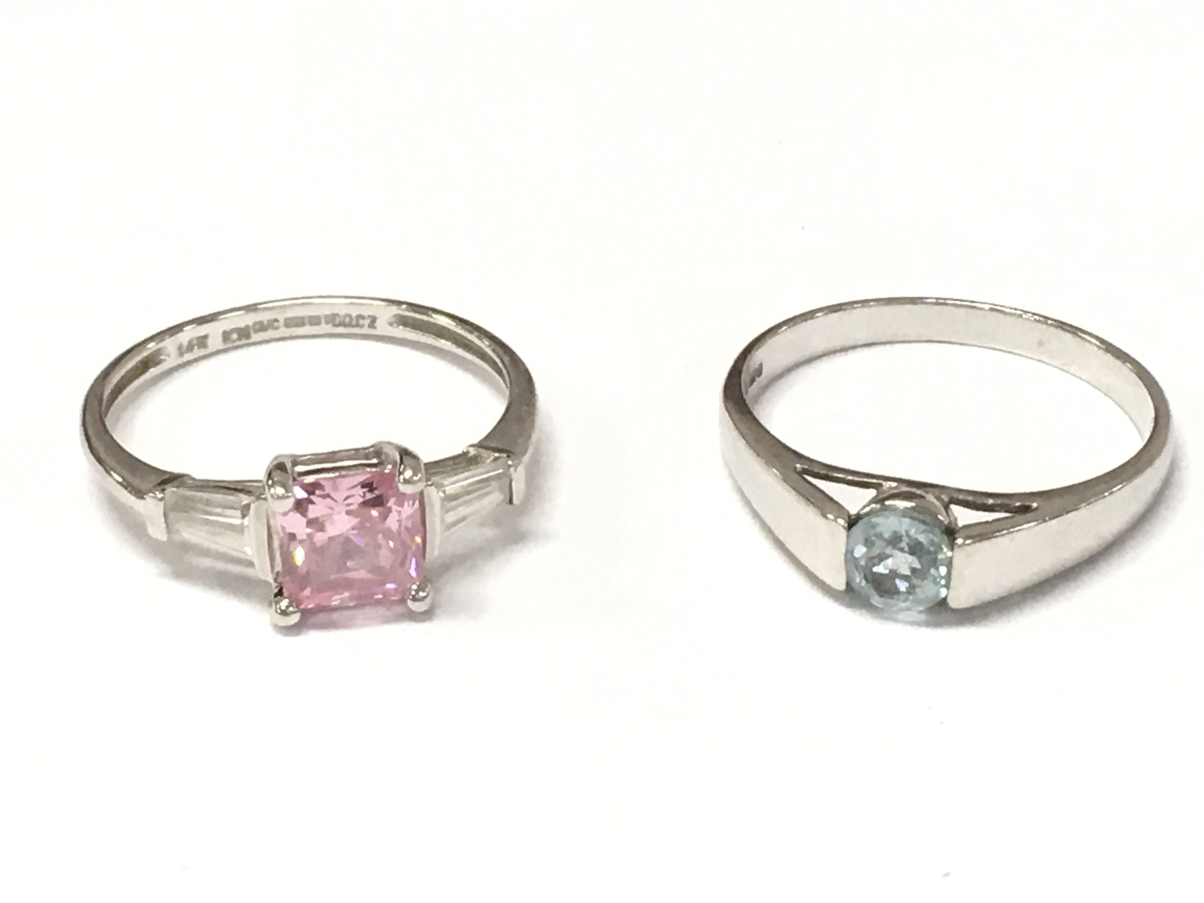A 14ct white gold ring set with cubic zirconia size Q and a 9ct white gold blue cubic zirconia ring size O. 2.3 and 2.8g Postage catA