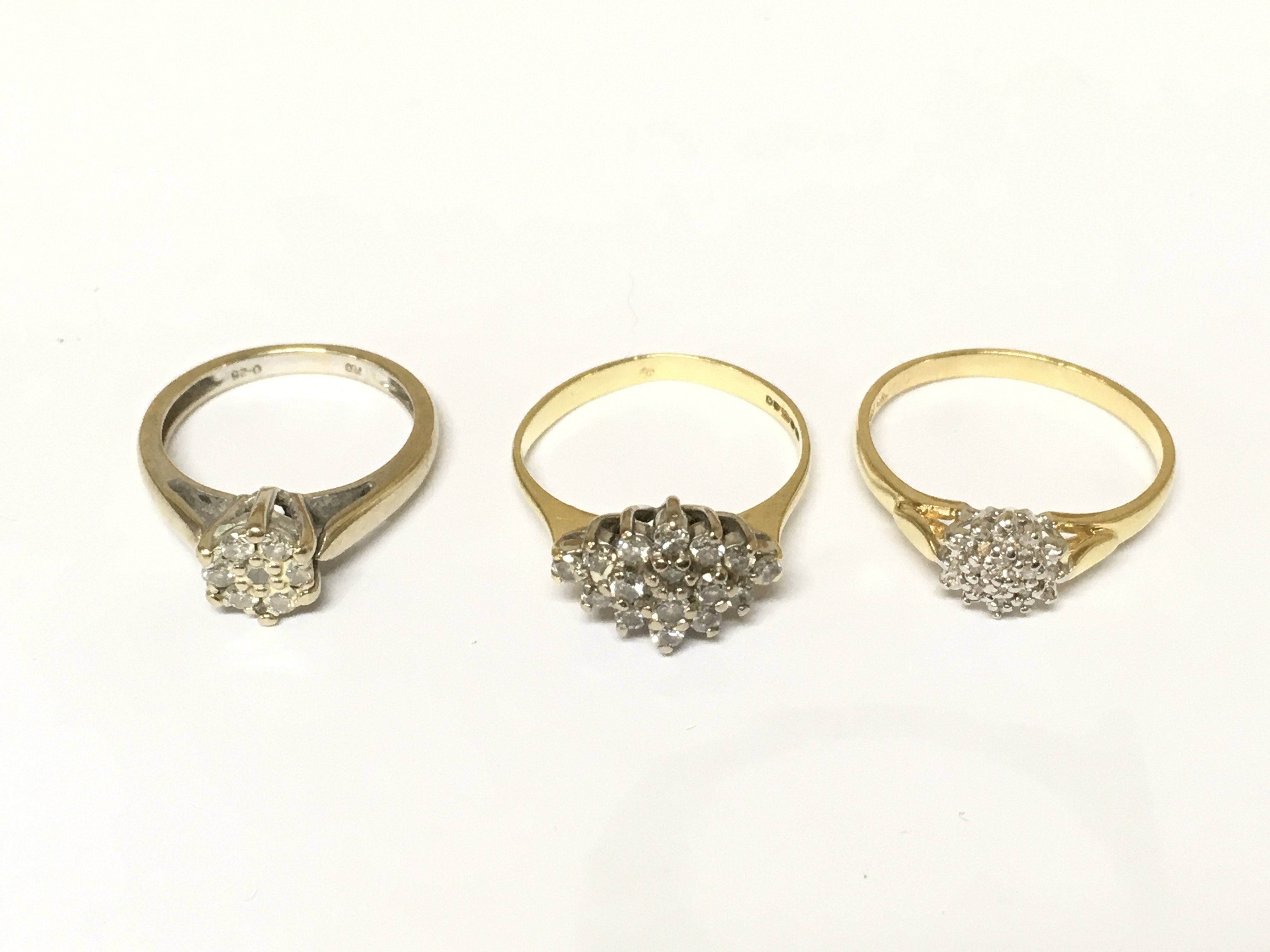 Three 18ct gold diamond cluster rings. Approximately 9.7g sizes K N and O