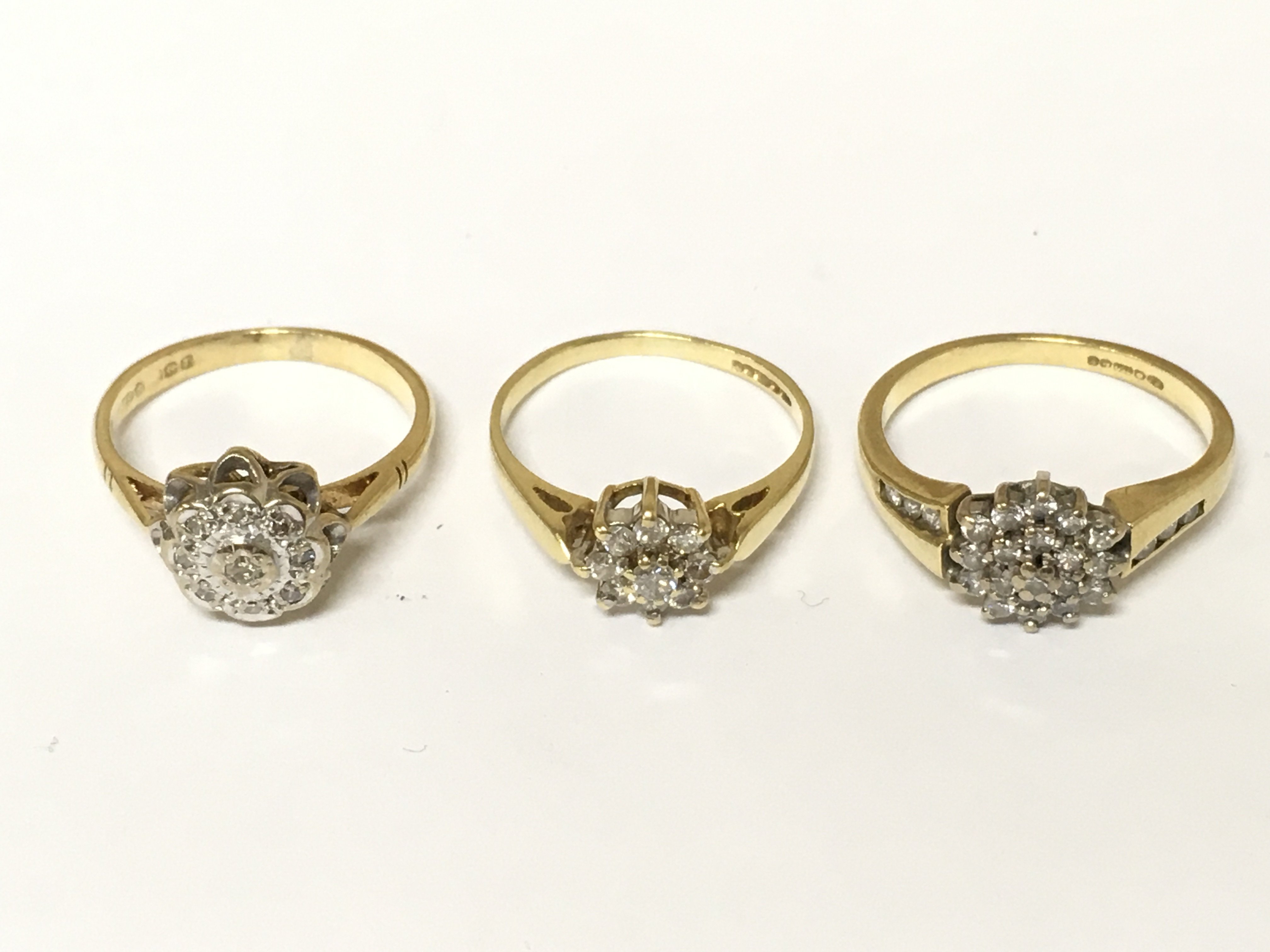 Three 18ct gold diamond cluster rings. Approximately 9.2g sizes K and M 1/2