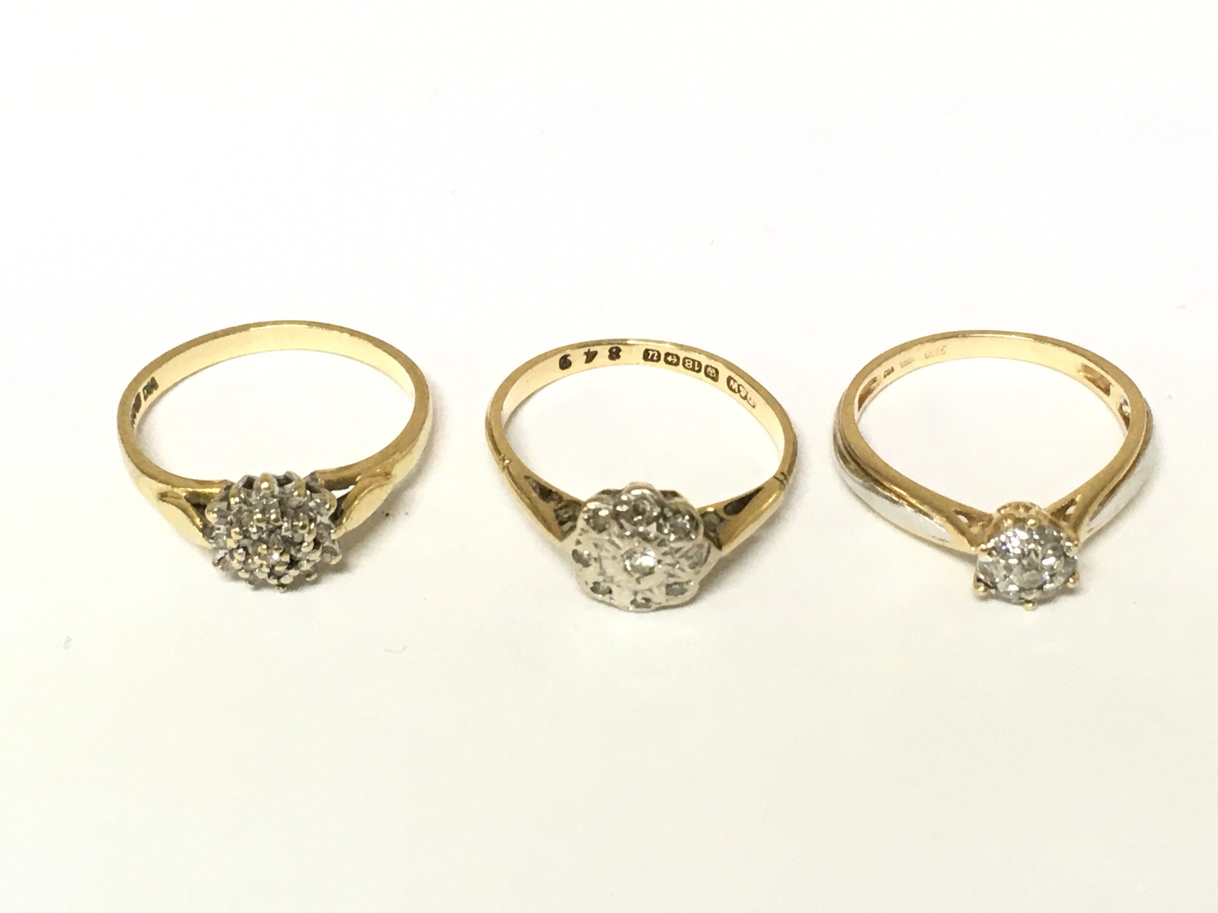 Three 18ct gold diamond cluster rings. Approximately 6.8g sizes J 1/2 and K
