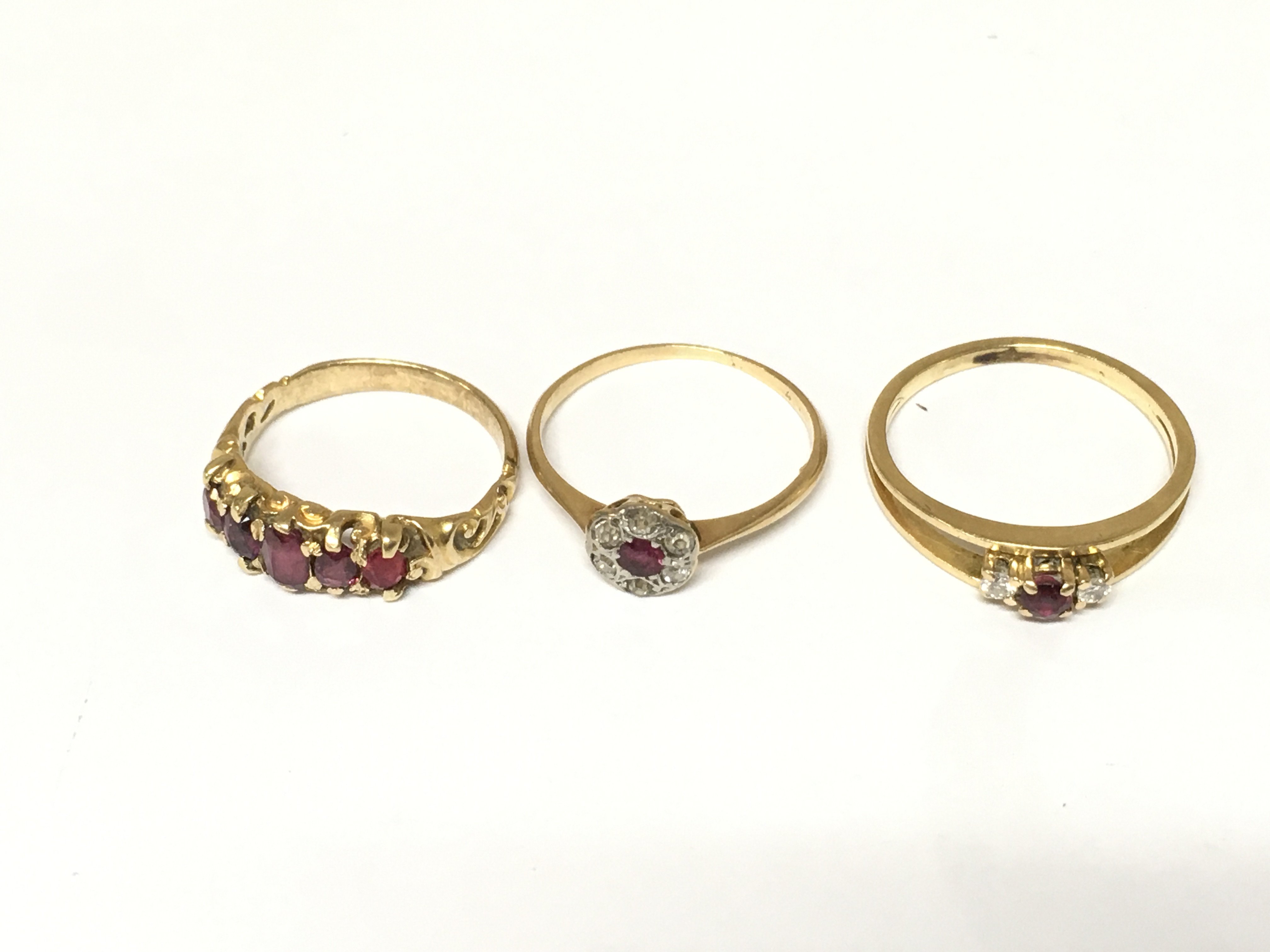 Three unmarked rings set with diamonds and rubies. Approximately 5.5g sizes H K and M