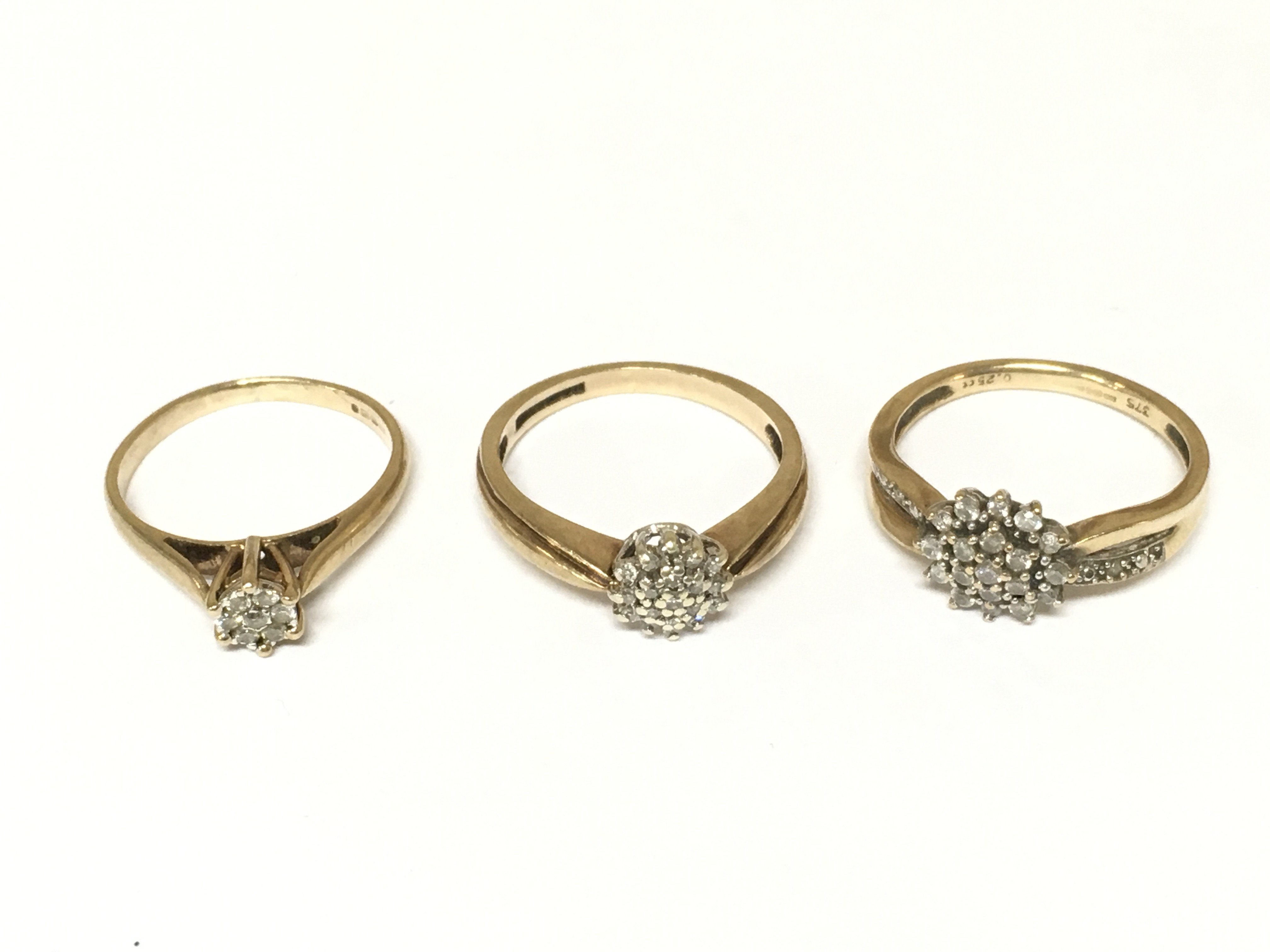 Three 9ct gold diamond cluster rings. Approximately 6.75g sizes K N & N 1/2