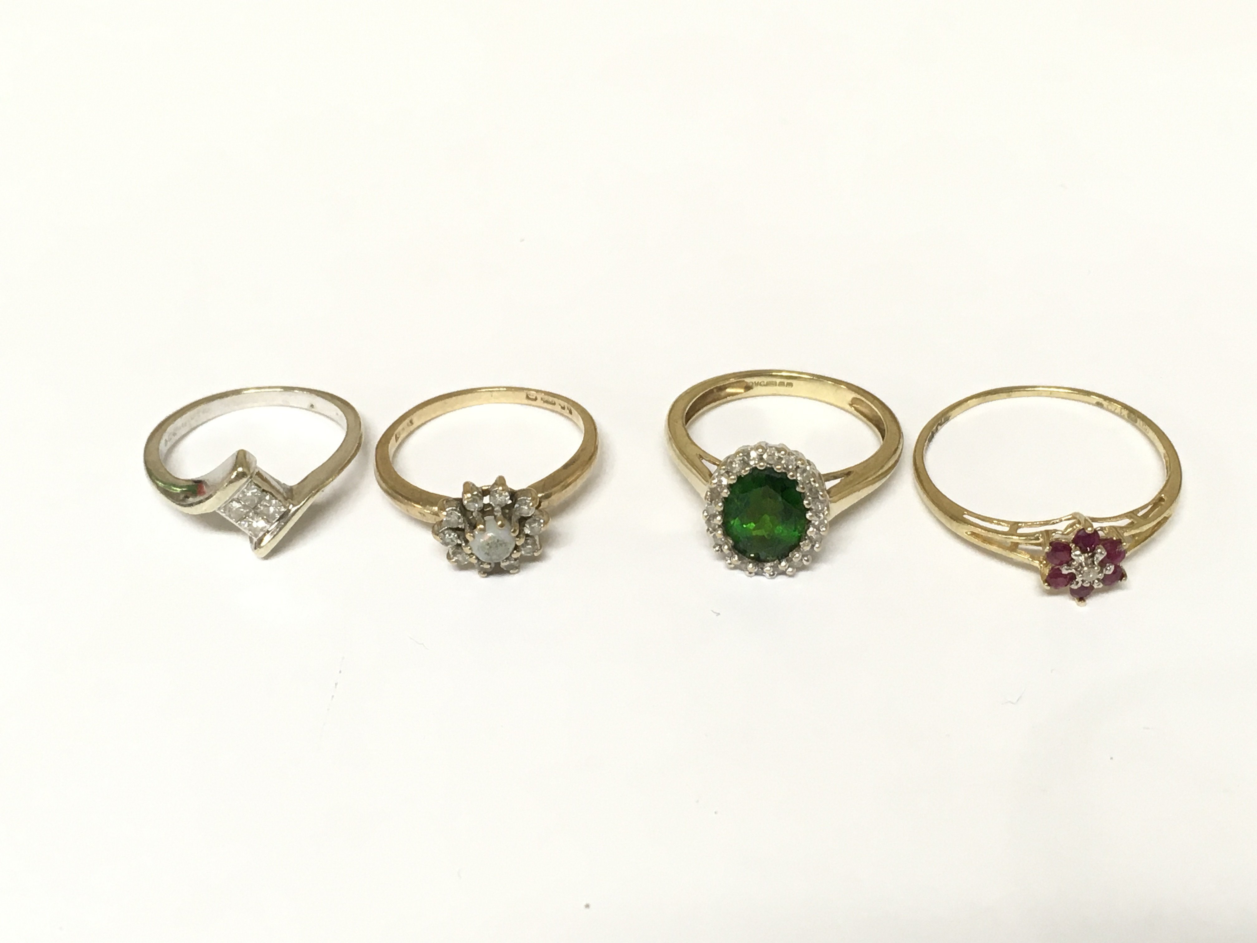Four 9ct gold rings set with diamonds and other gem stones. Approximately 6g and sizes F H1/2 I and p