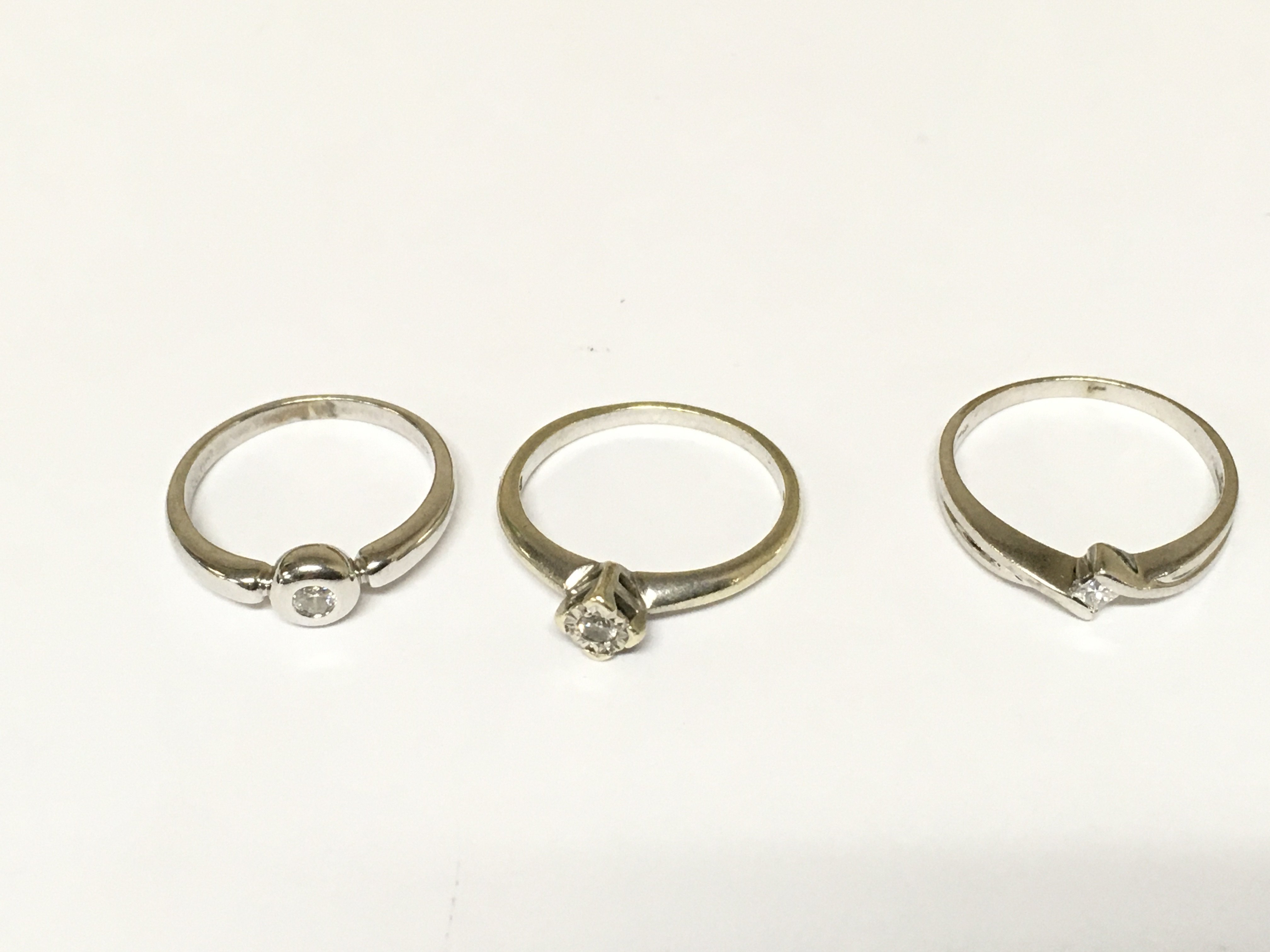 Three 9ct white gold diamond solitaire rings. Approximately 5.7g and sizes K L and N