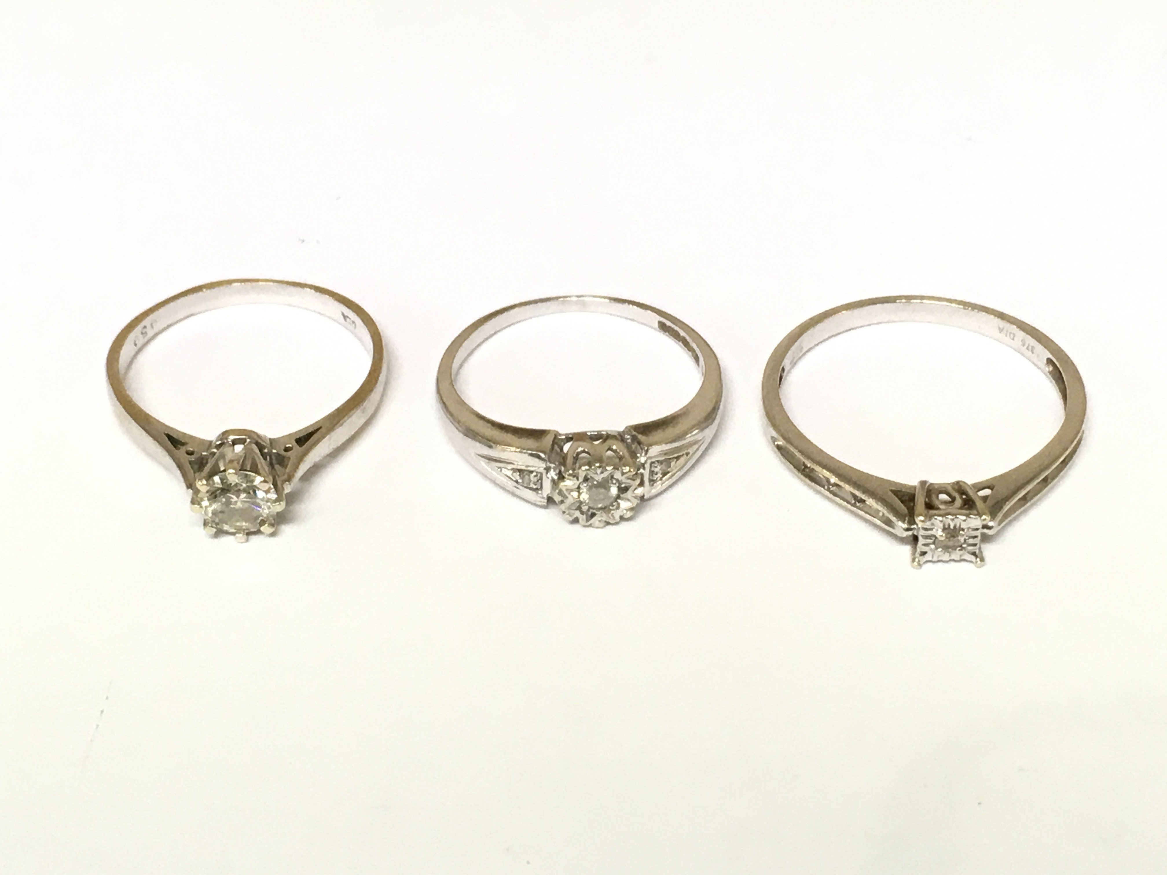 Three 9ct white gold diamond solitaire rings. Approximately 6.3g and sizes N and S