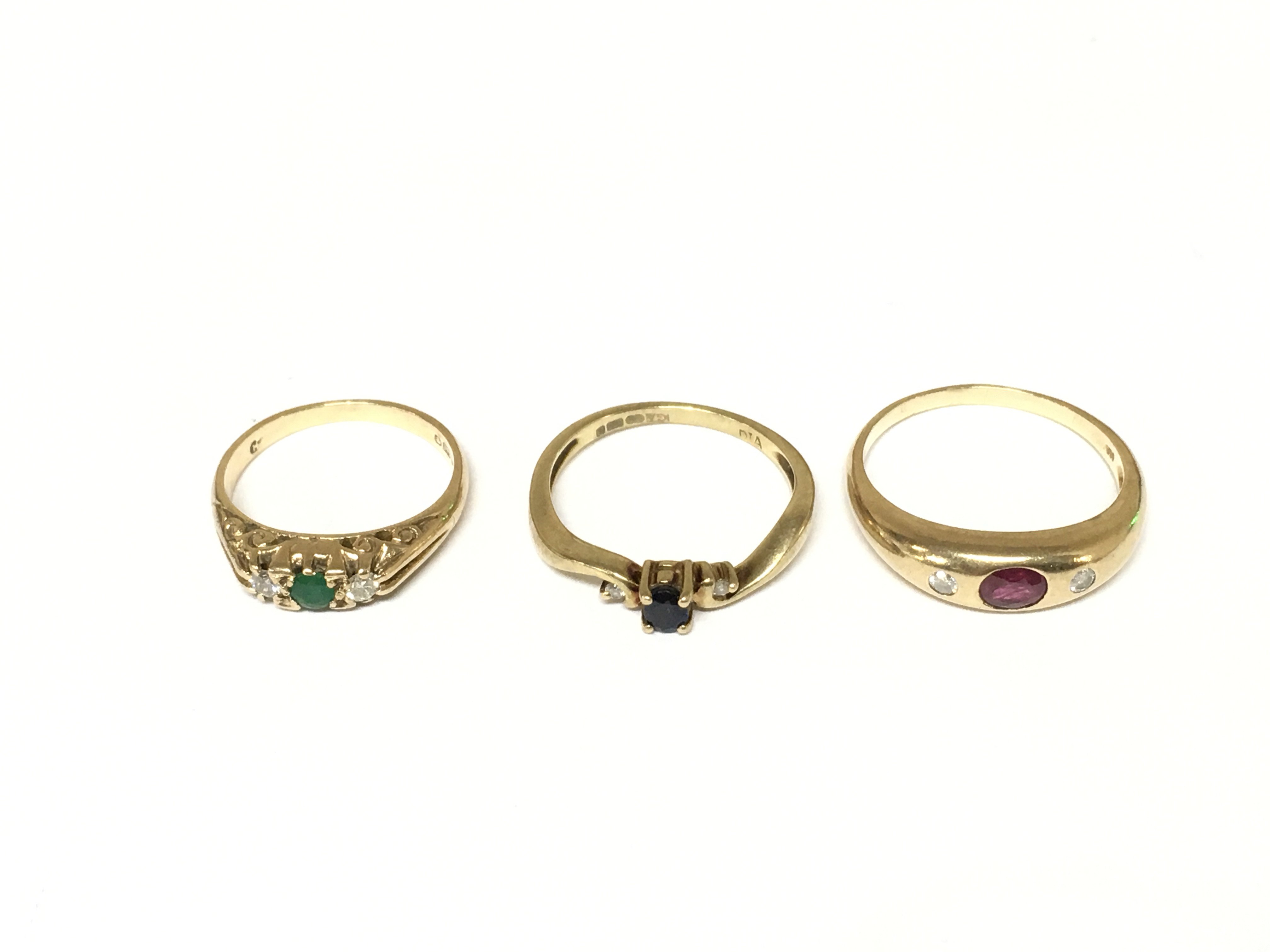 Three 9ct gold rings set with mixed gem stones. Approximately 7g and sizes L O and R