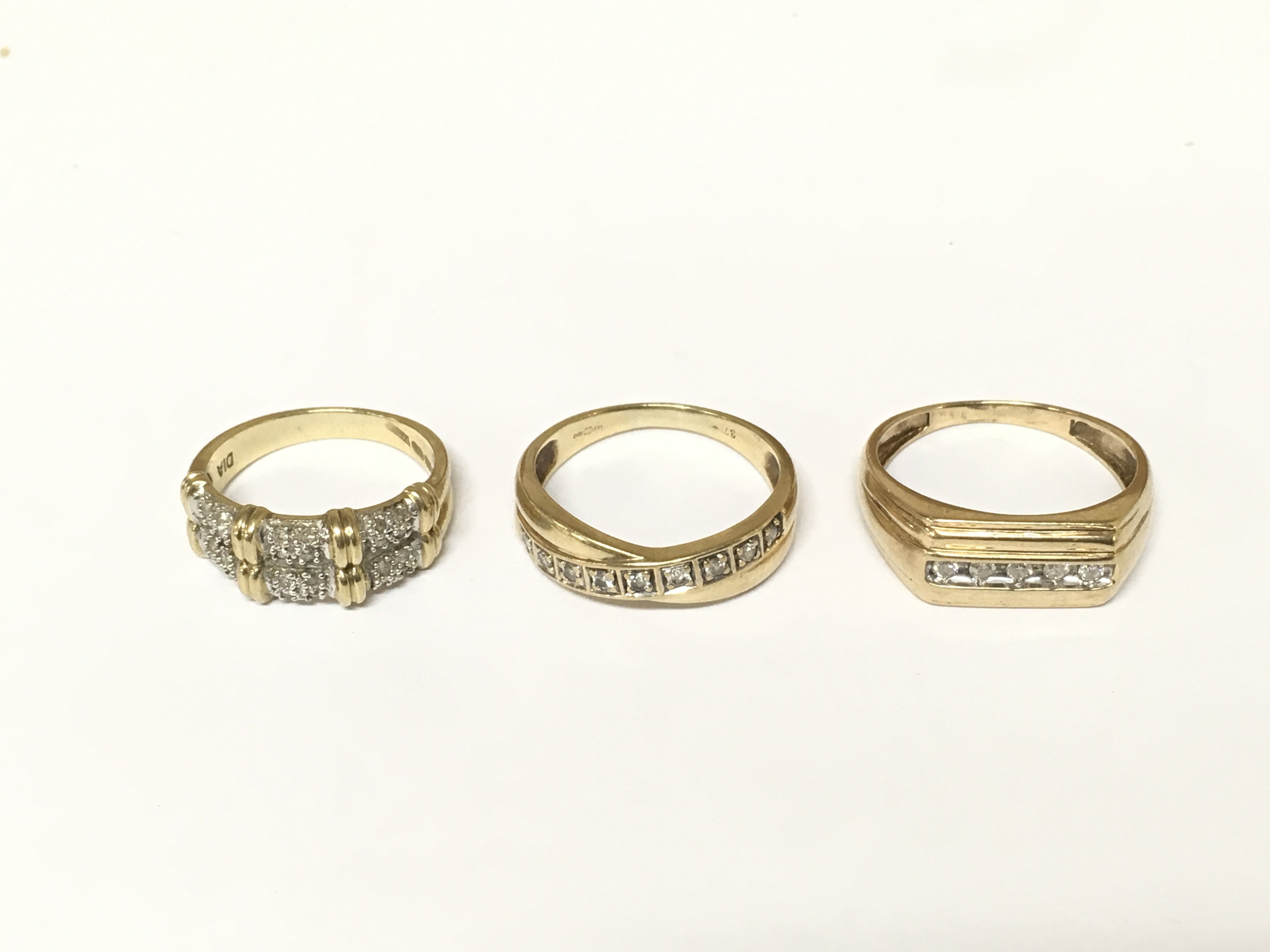 Three 9ct gold diamond band rings. Approximately 8g and sizes L and P