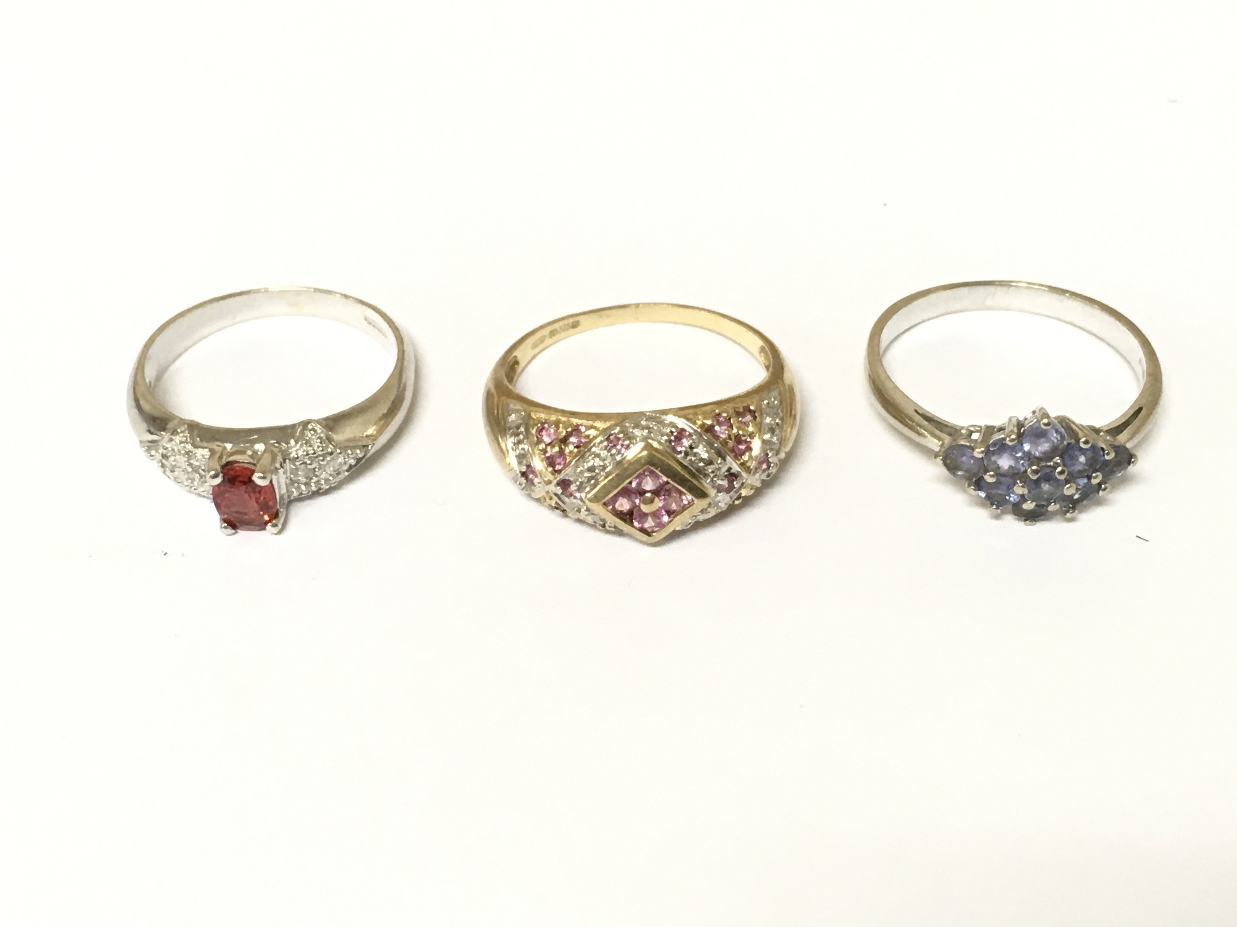 Three 9ct gold cluster rings set with assorted stones. Approximately 7.5g and sizes N and P