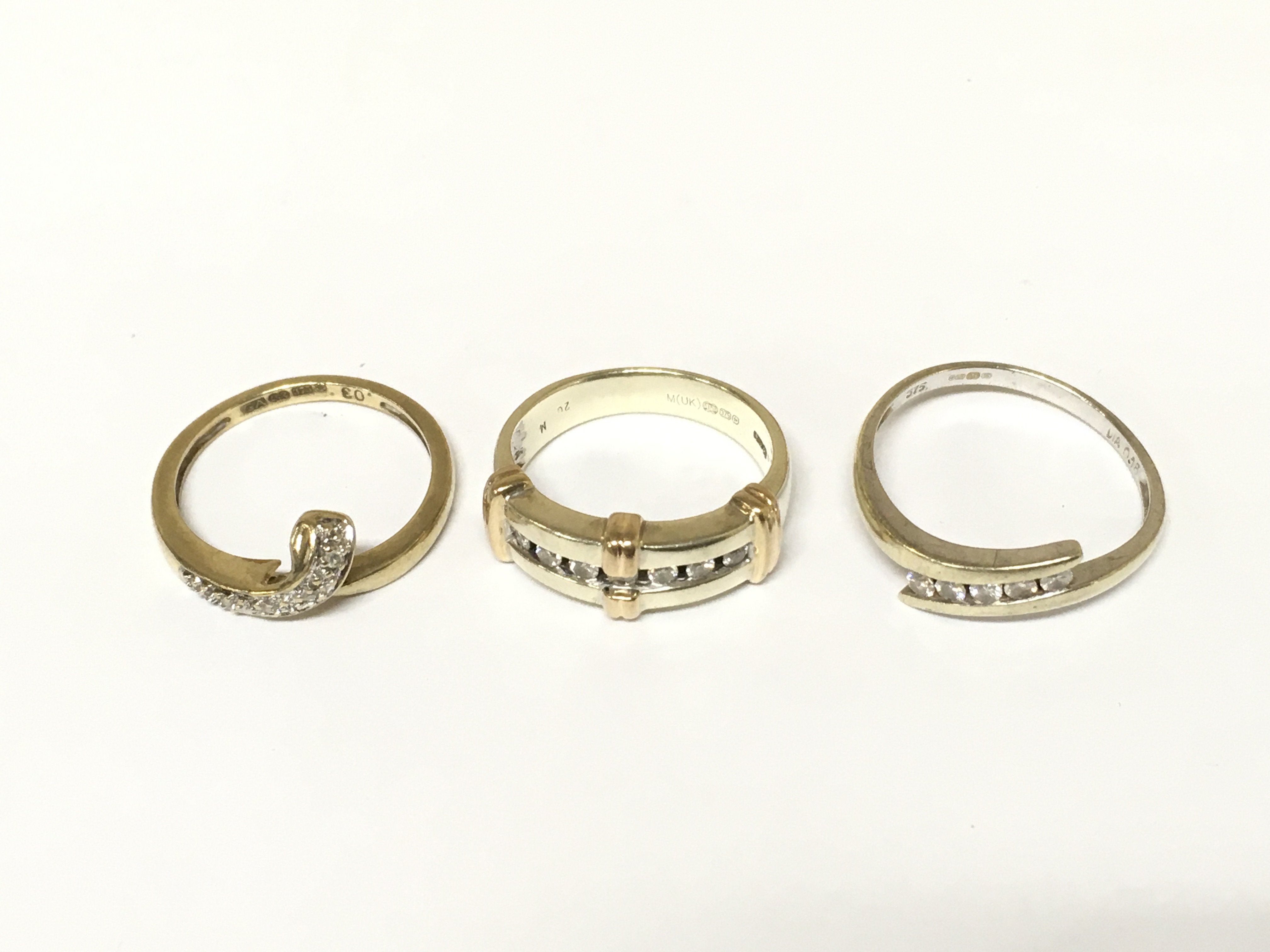 Two 9ct white gold diamond band rings and a 9ct yellow gold band ring. Approximately 8.8g and sizes K 1/2 M and Q