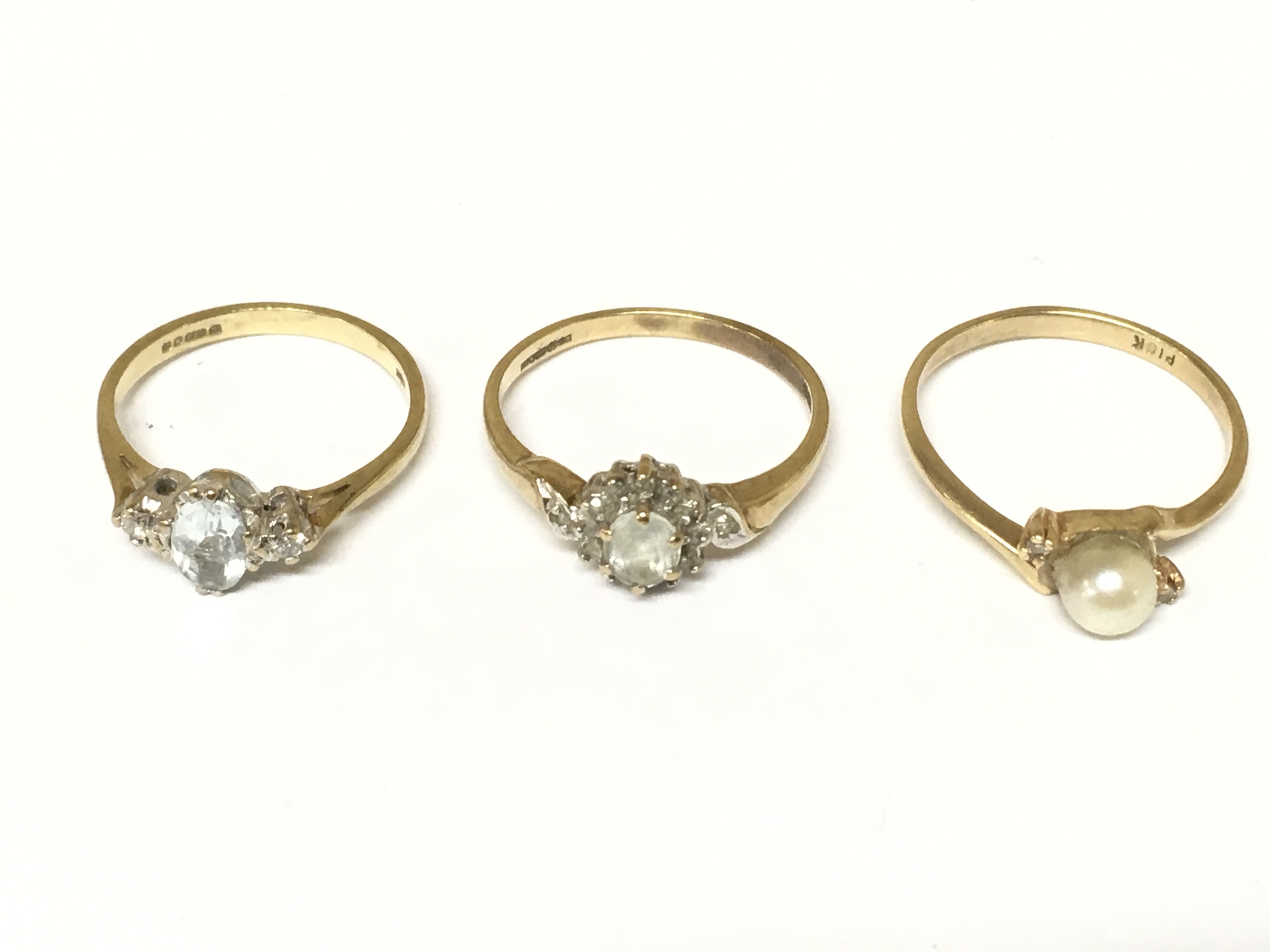 Three 9ct gold rings set with assorted gems and stones. Approximately 4.6g and sizes I 1/2 L 1/2