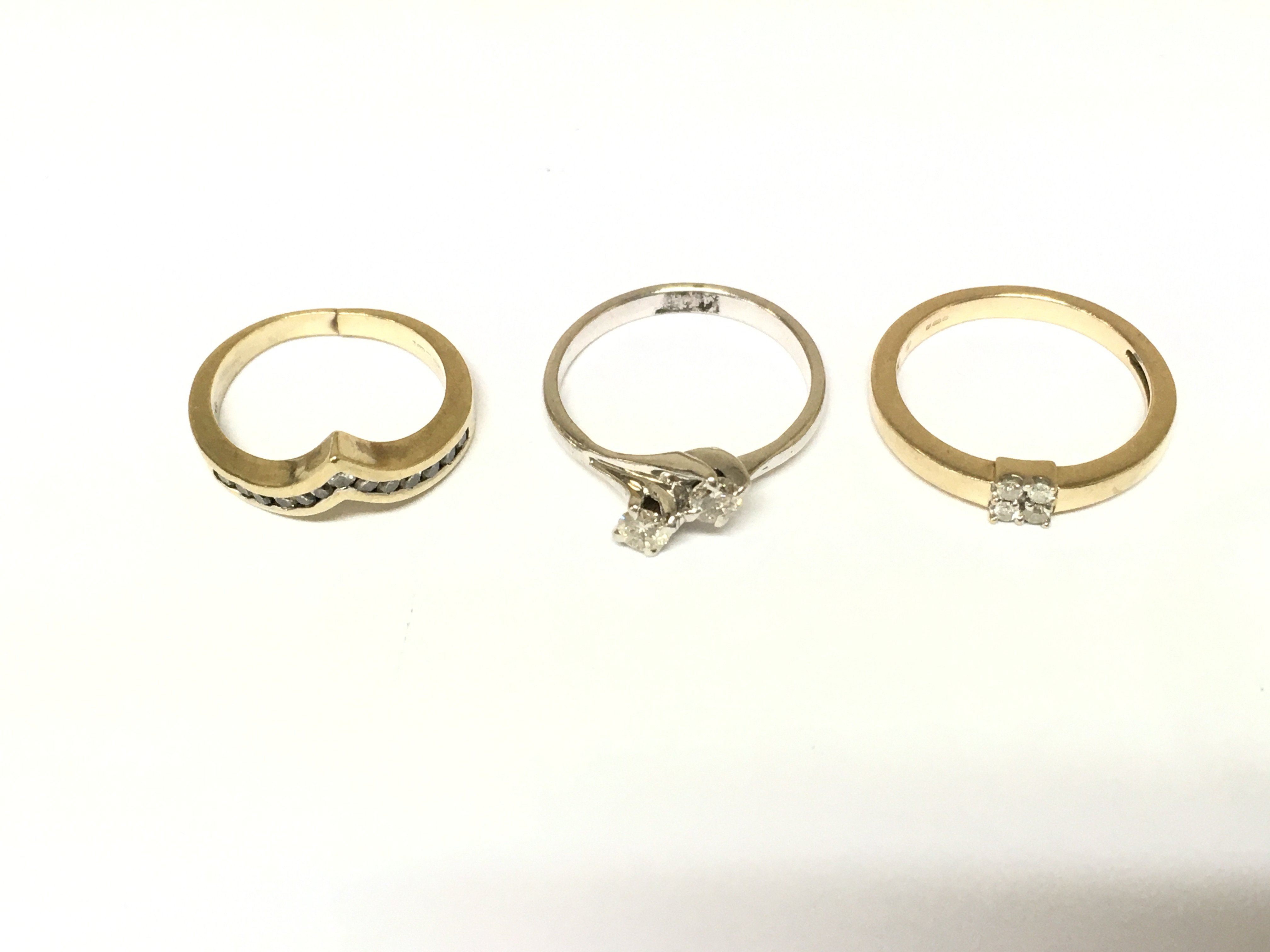 Three 9ct gold rings set with diamonds. Approximately 8.2g and sizes I N O