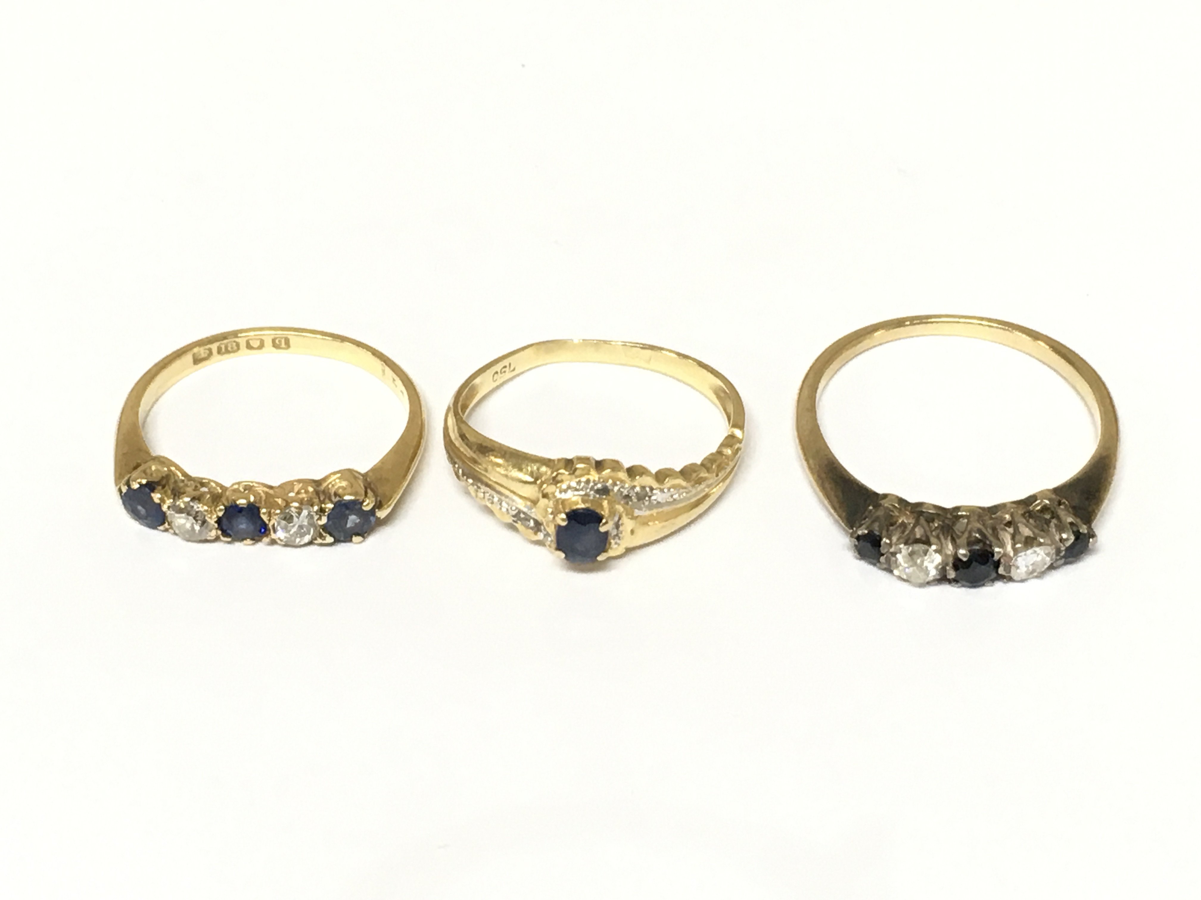 Three 18ct gold diamond and sapphire set rings. Approximately 6.6g and sizes J L and O