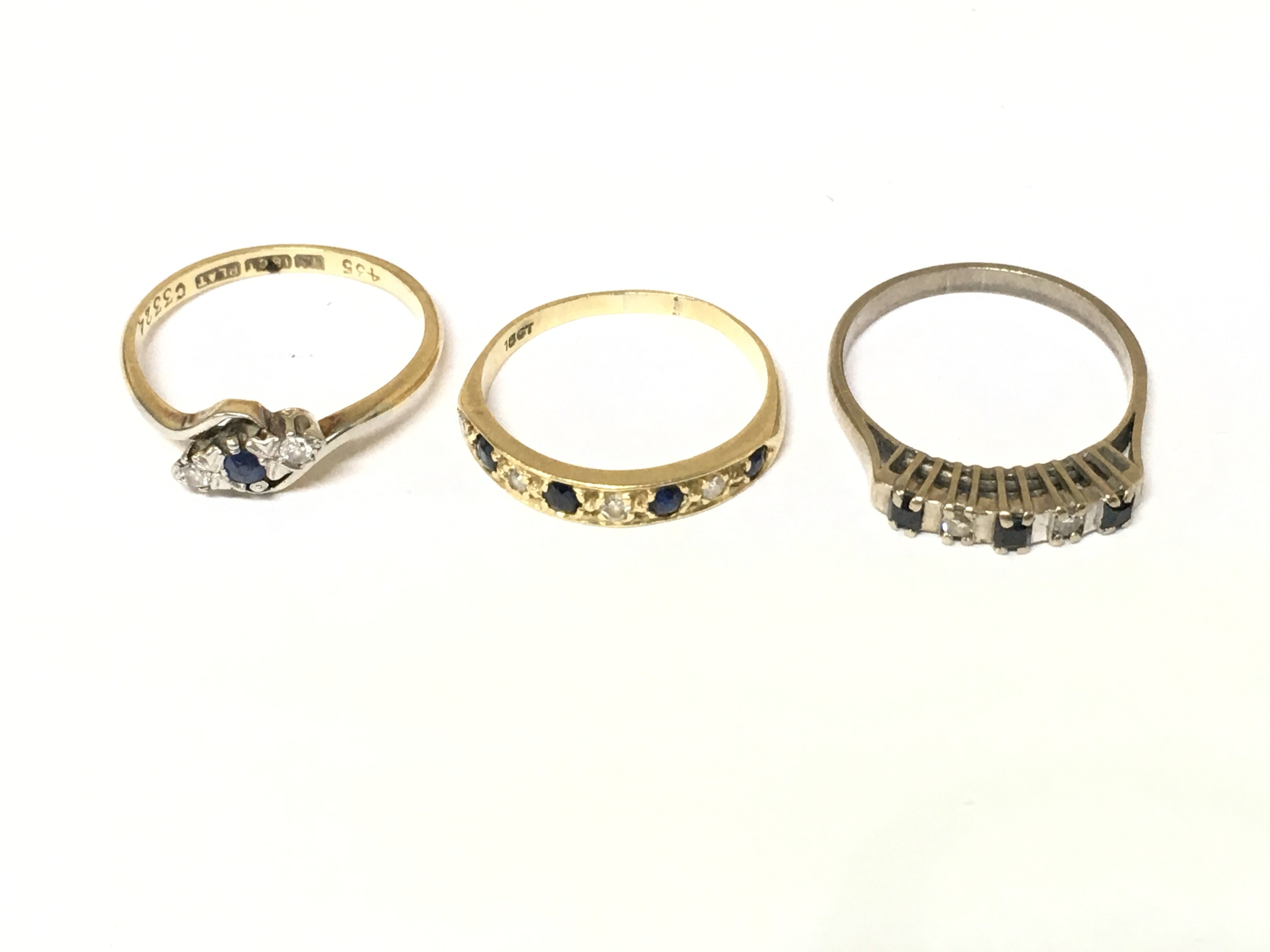 Three 18ct gold diamond and sapphire set rings one is white gold. Approximately 7.7g size O and P