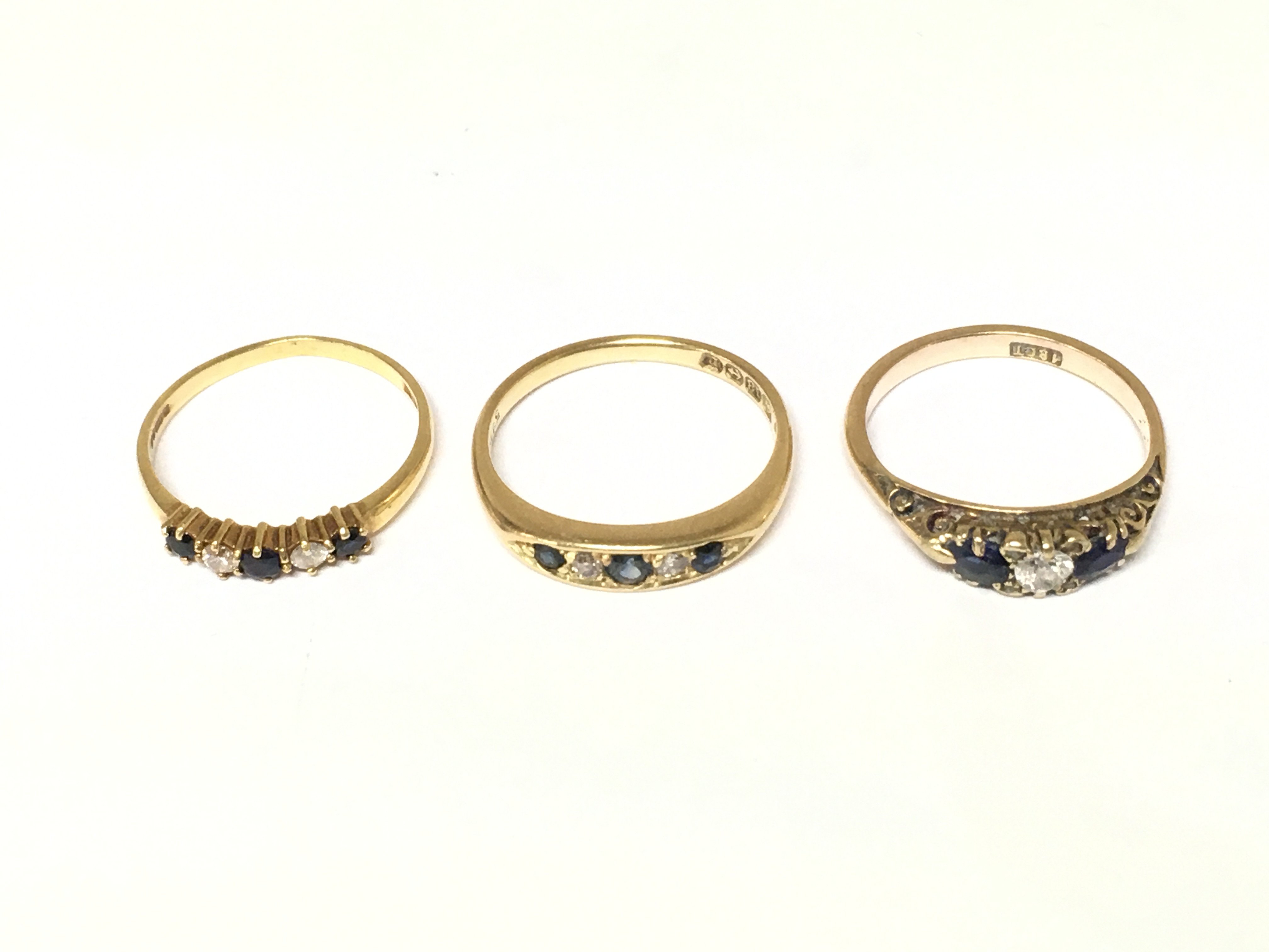 Three 18ct gold diamond and sapphire set rings. Approximately 7.5g sizes M N and O