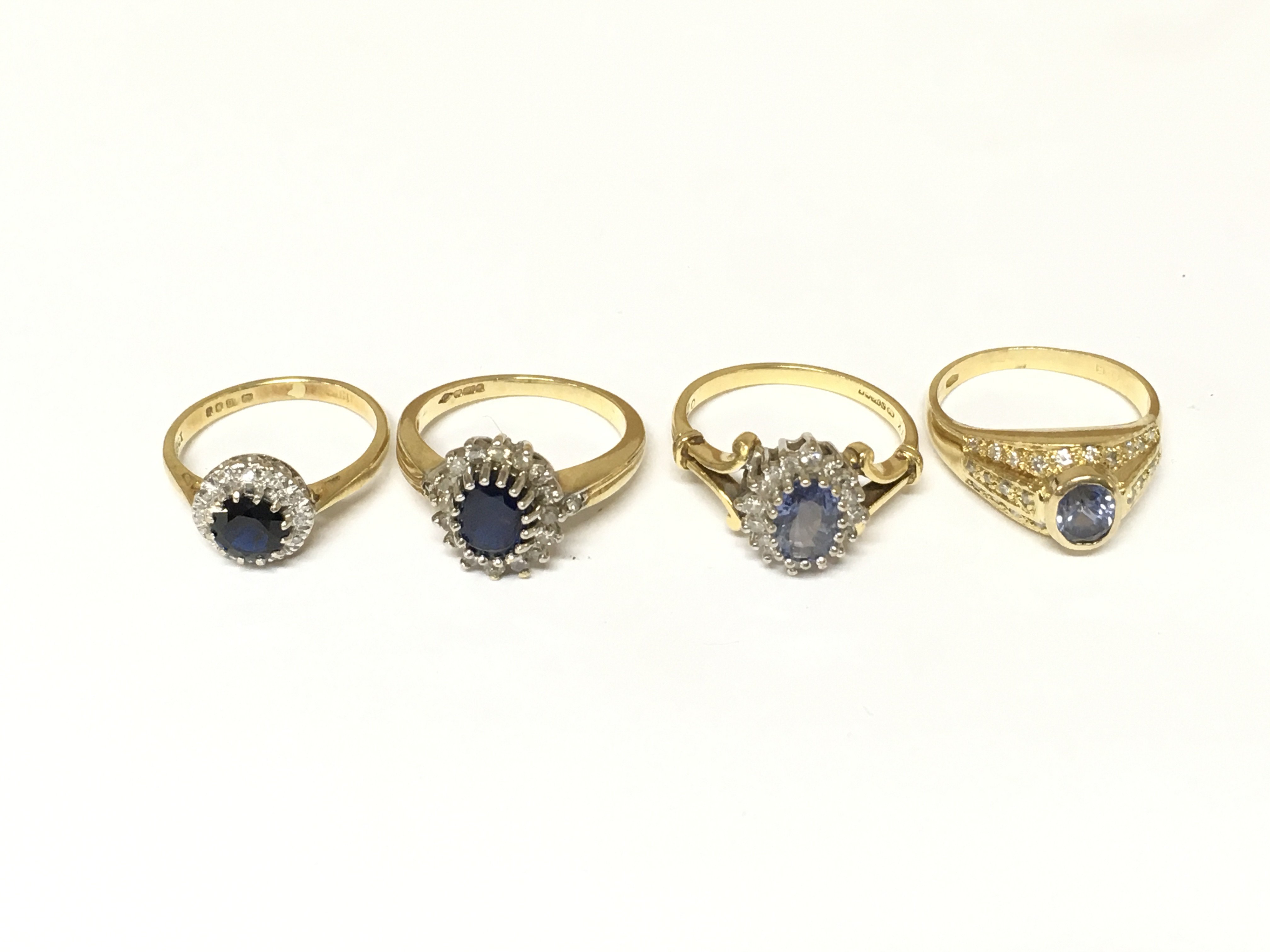 Four 18ct gold diamond and sapphire cluster rings. Approximately 14.4g sizes I J K M