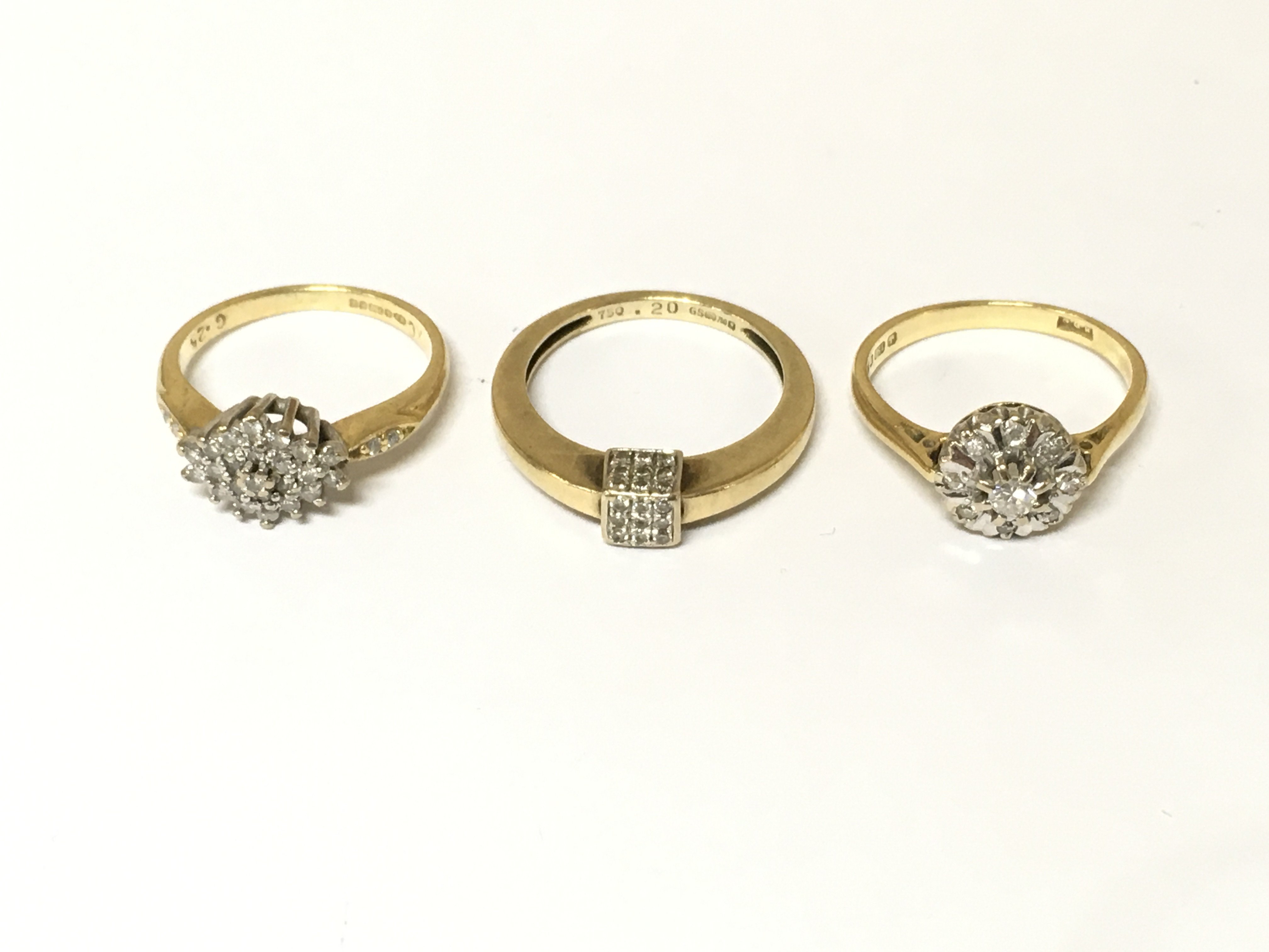 Three 18ct gold diamond cluster rings. Approximately 9.6g sizes J L 1/2
