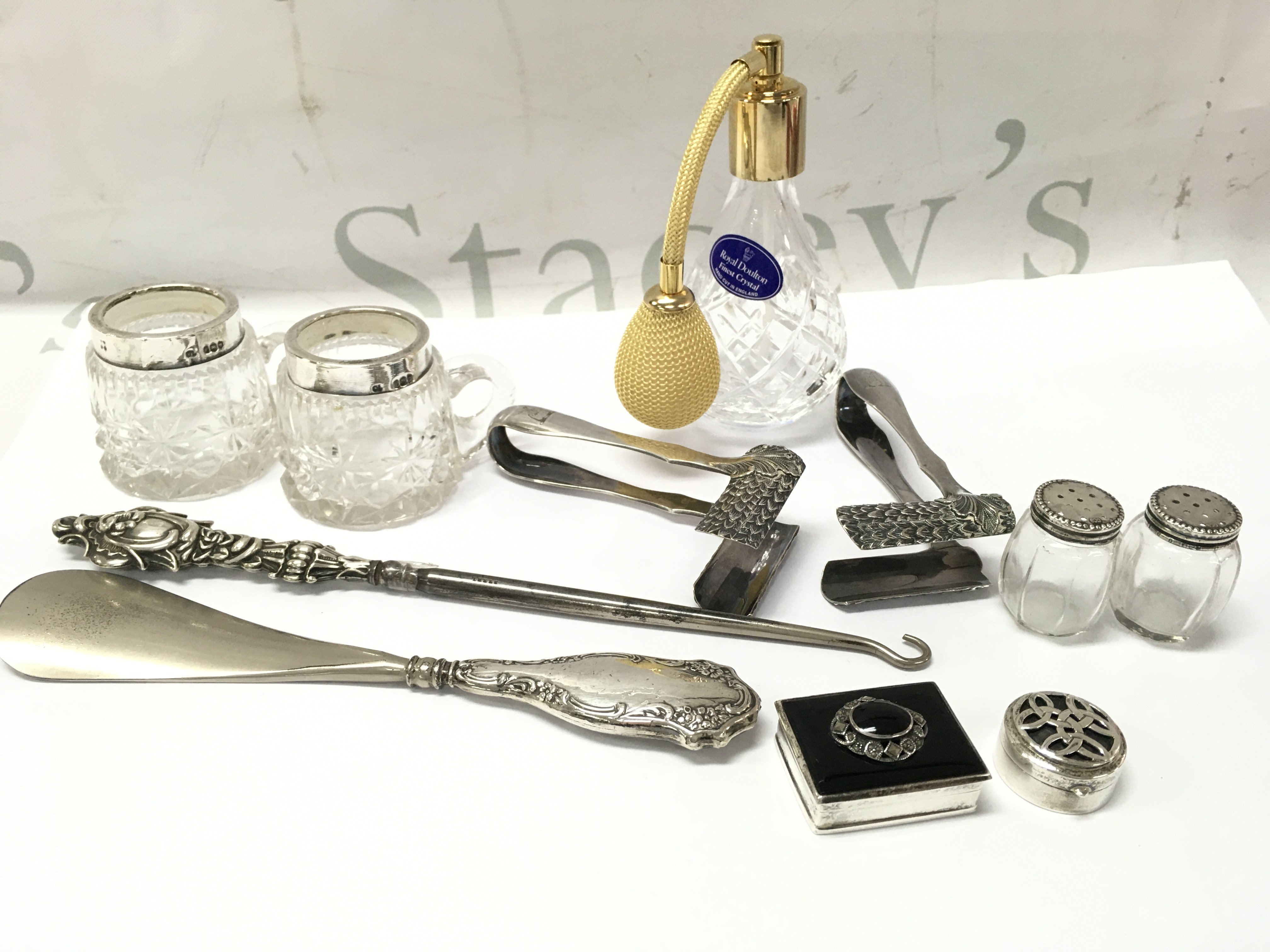 A Collection of silver including pill boxes, crochet hook, small cut glass silver topped cups and silver plated items including a rare pair of Asparagus tongs . This lot cannot be posted