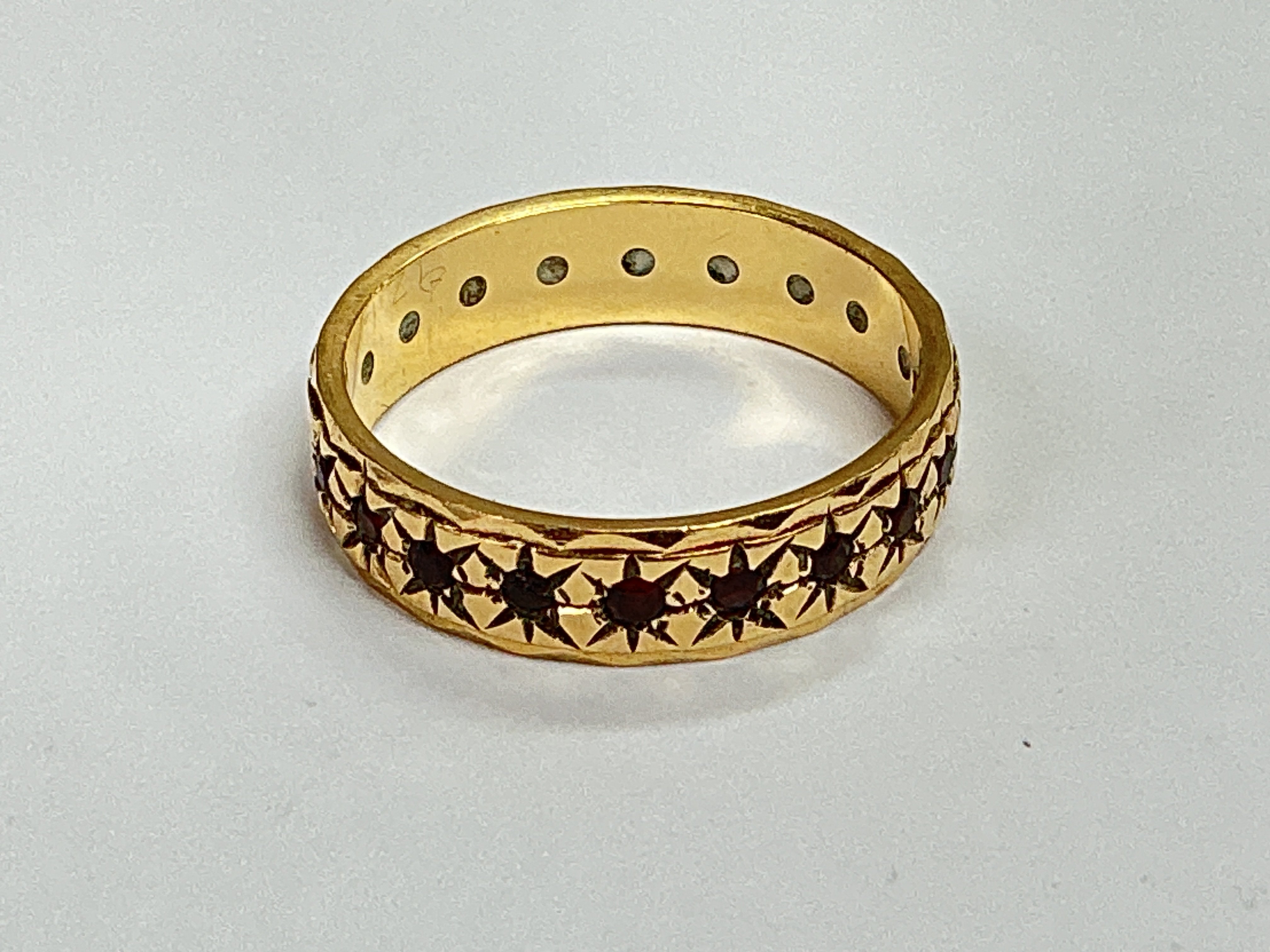 a 9ct gold eternity ring set with rubys. Approx weight 2.84 grams, approx size N.