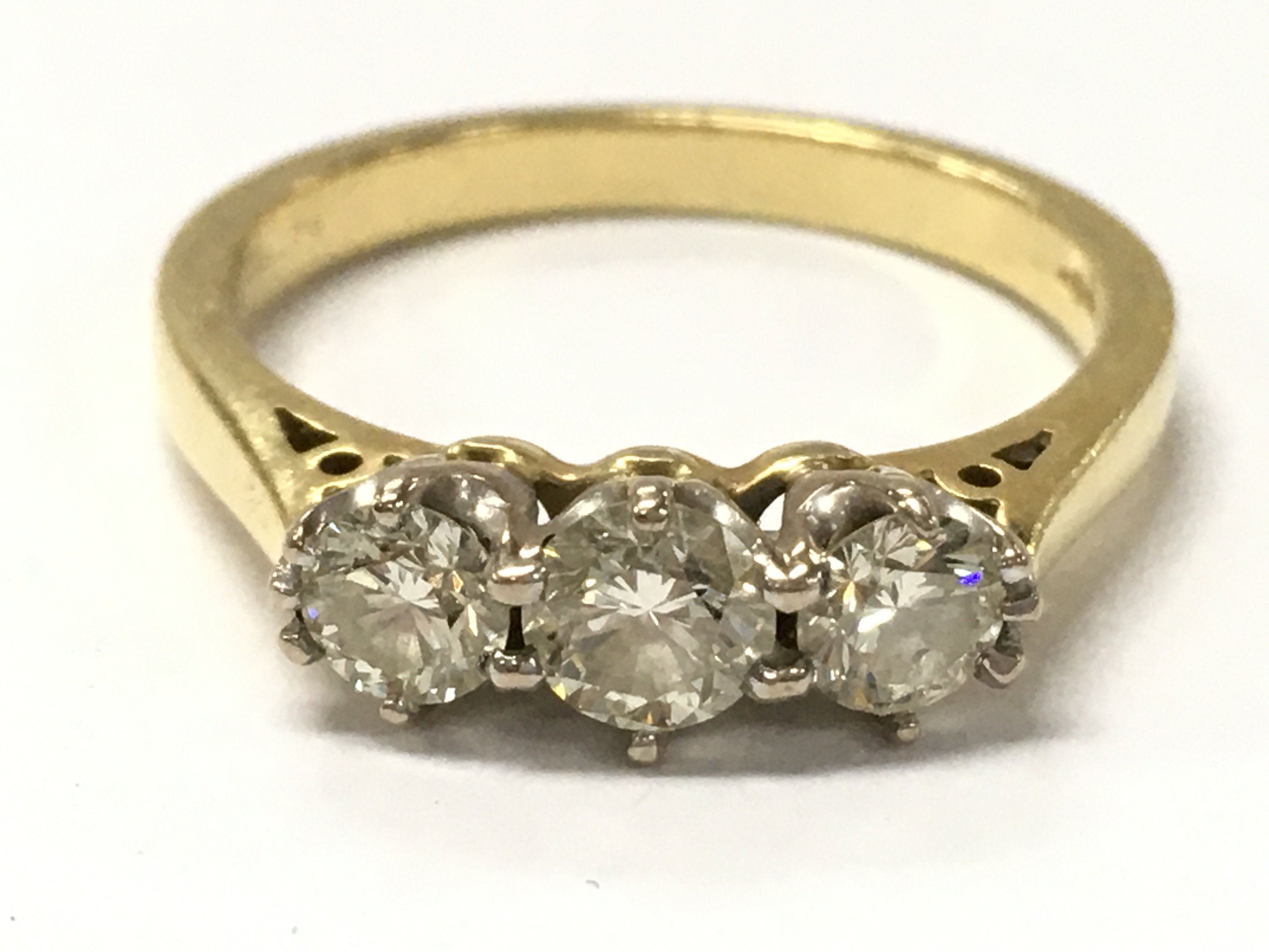 An 18ct yellow gold 0.75ct trilogy diamond ring . 3.9g total weight. Size O. Postage category A