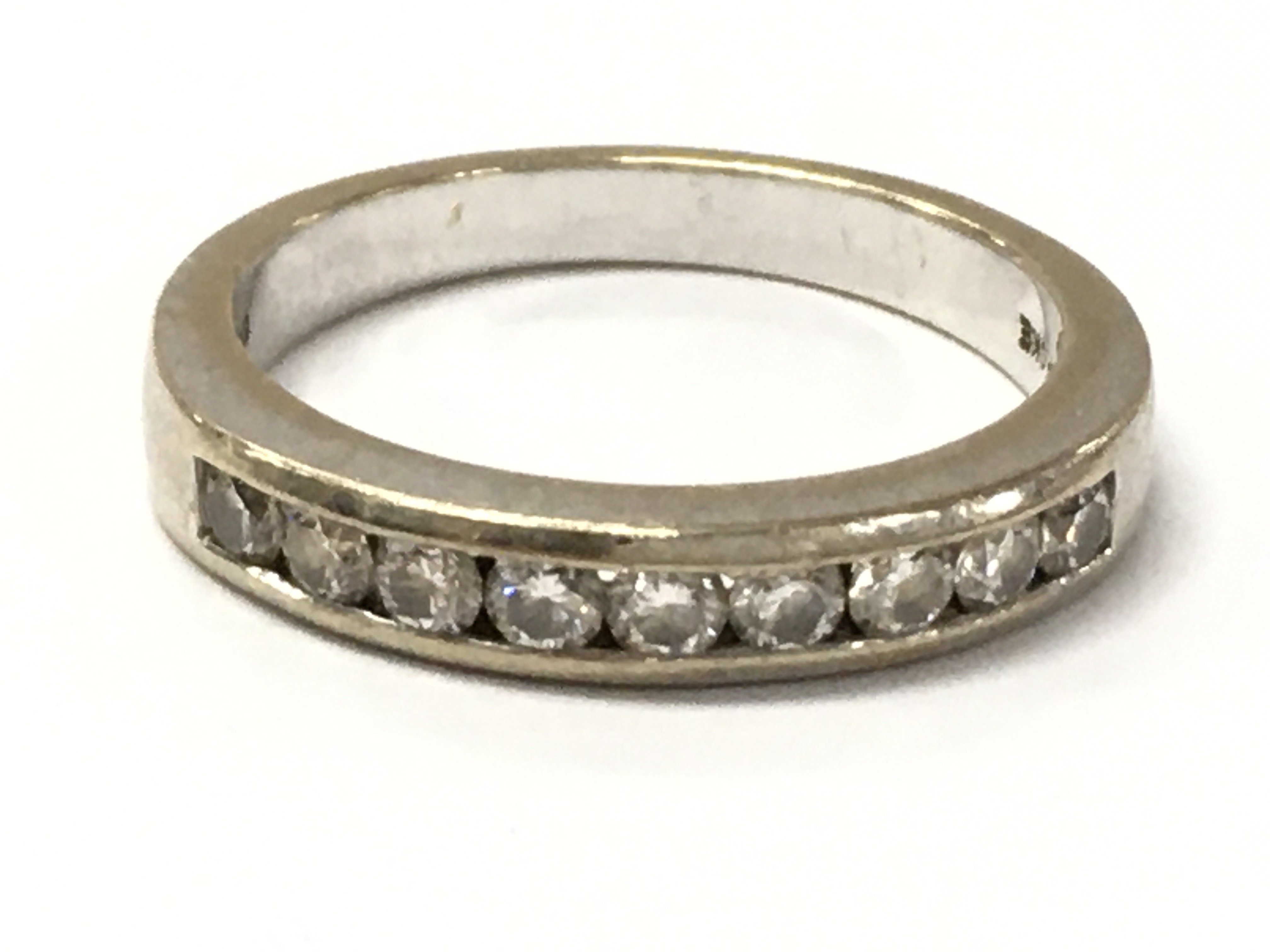 A 9 stone 18ct gold half eternity ring. 4.8g total weight. Size N. Postage category A