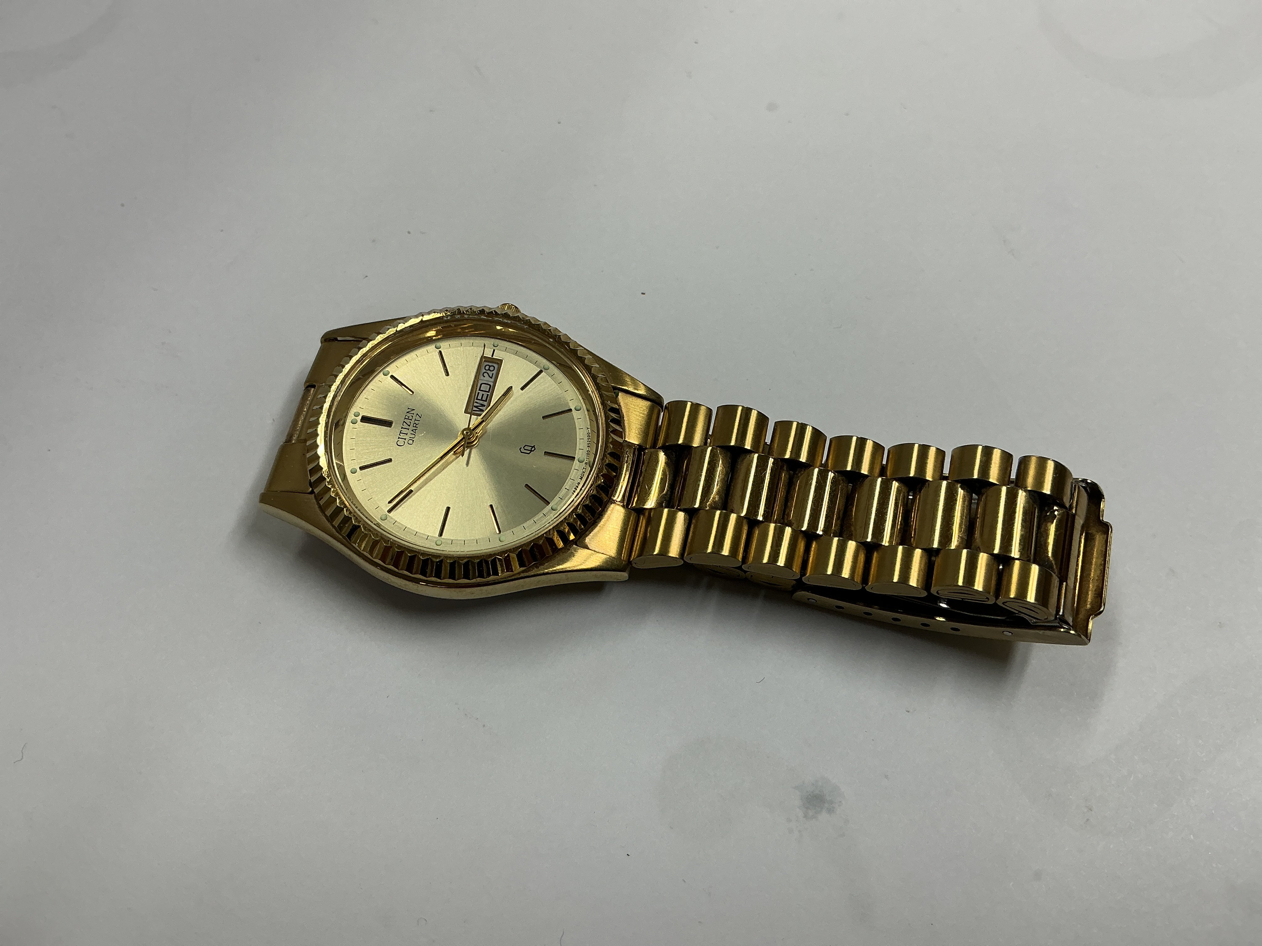 a gents gold coloured citizen dress watch.