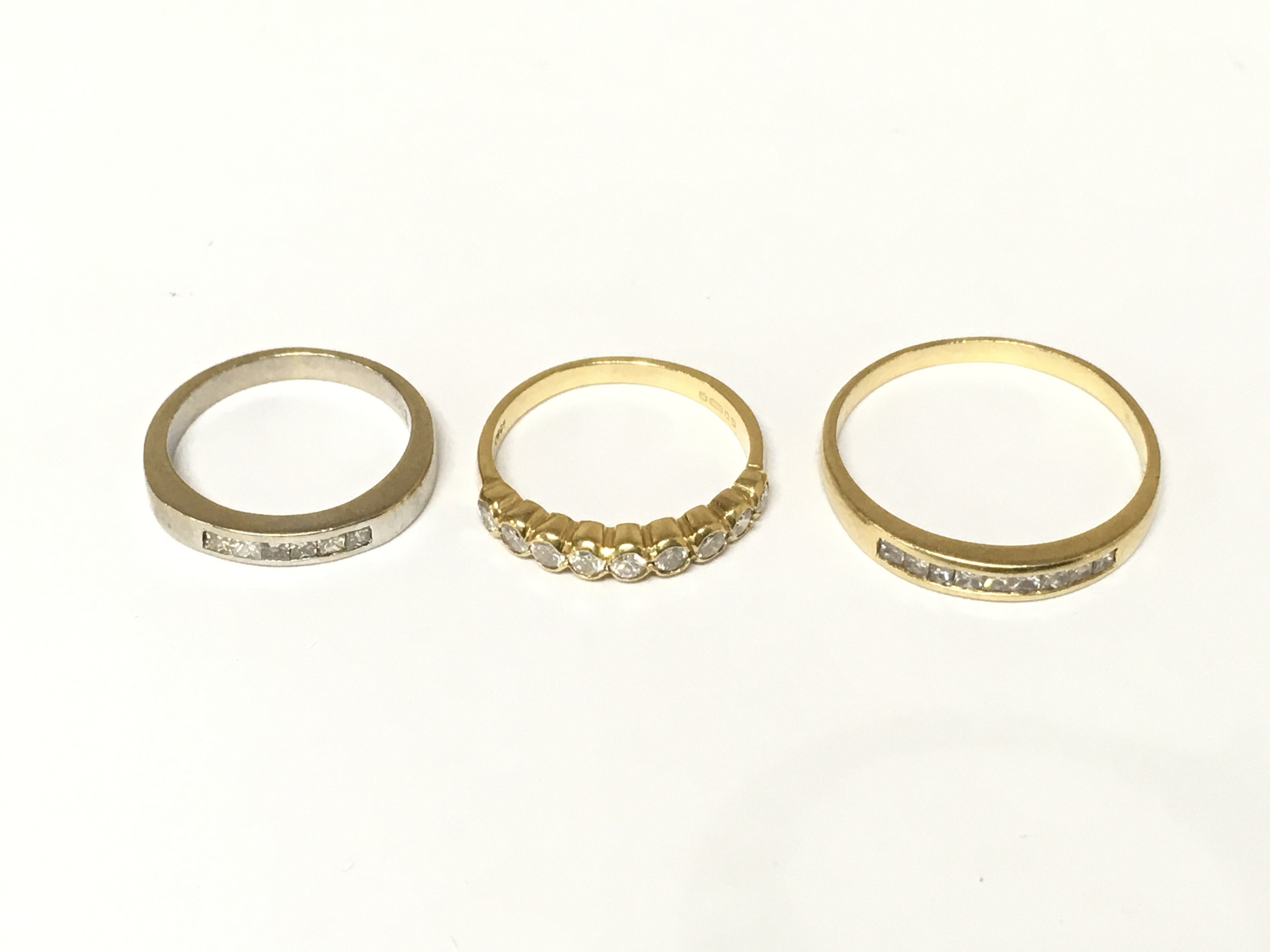Three 18ct gold half hoop diamond rings. Approximately 6.5g and sizes G 1/2 I and R