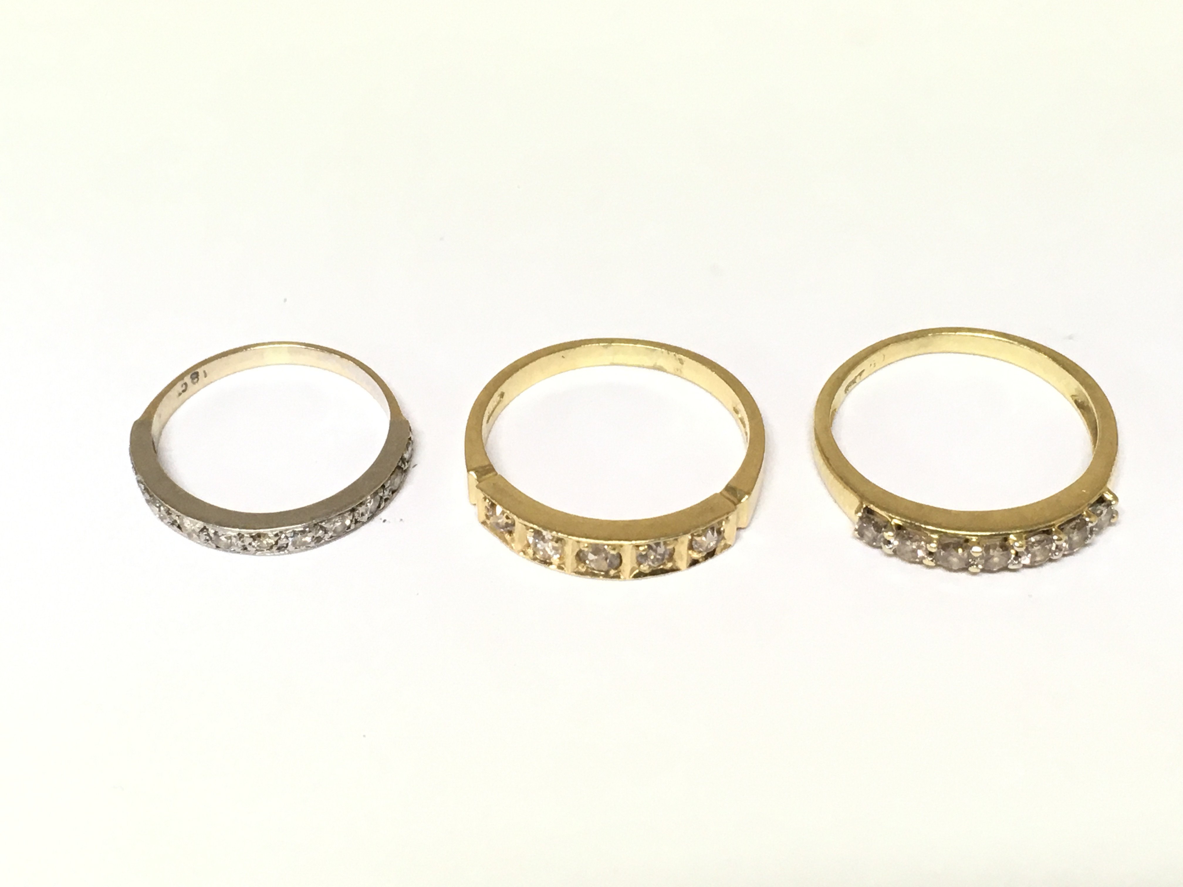 Three 18ct gold half hoop diamond rings. Approximately 8.3g sizes K and P