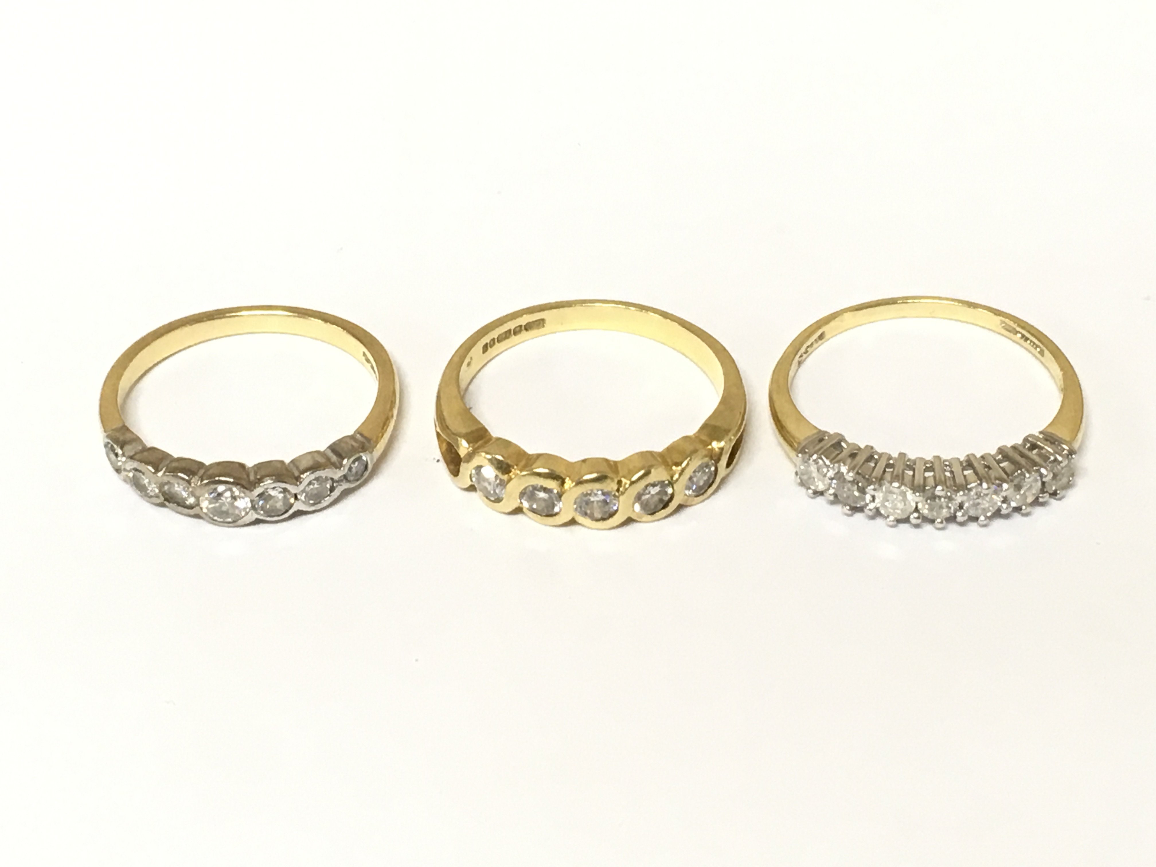 Three 18ct gold half hoop diamond rings. Approximately 9.3g and sizes M O P