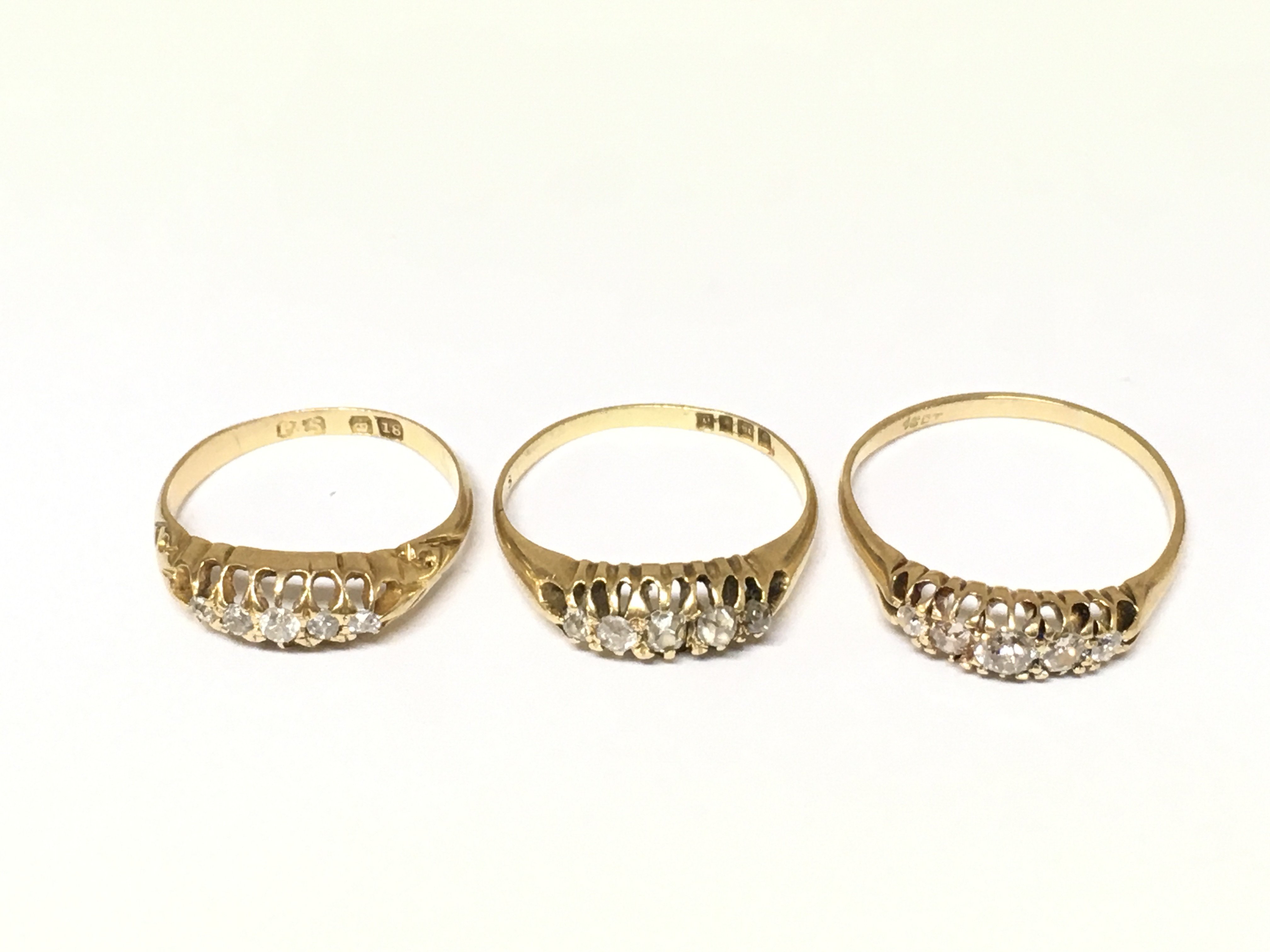 Three 18ct gold 5 stone diamond rings. Approximately 6.9g and sizes J N and Q