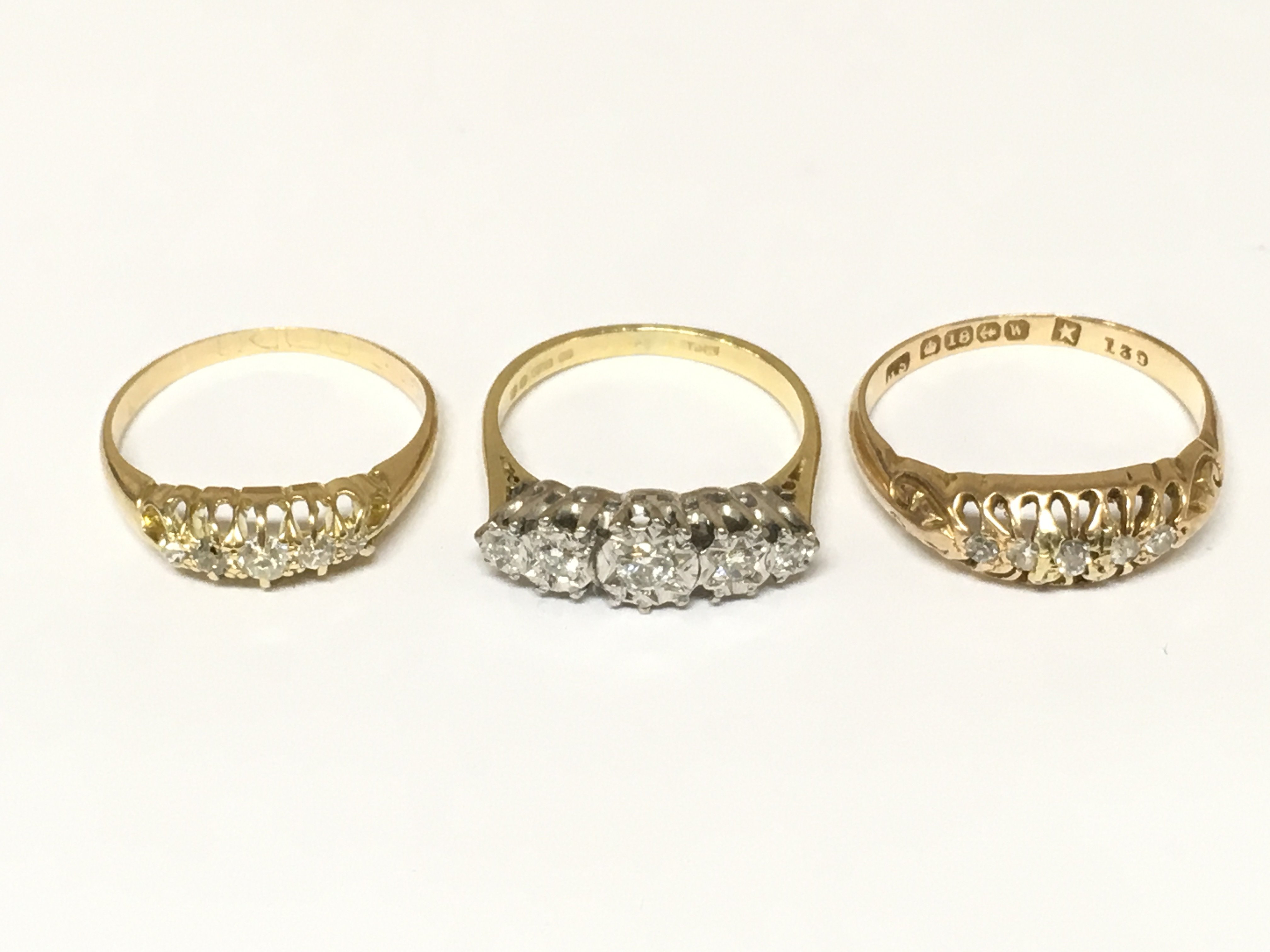 Three 18ct gold 5 stone diamond rings. Approximately 6.9g and sizes J K and O