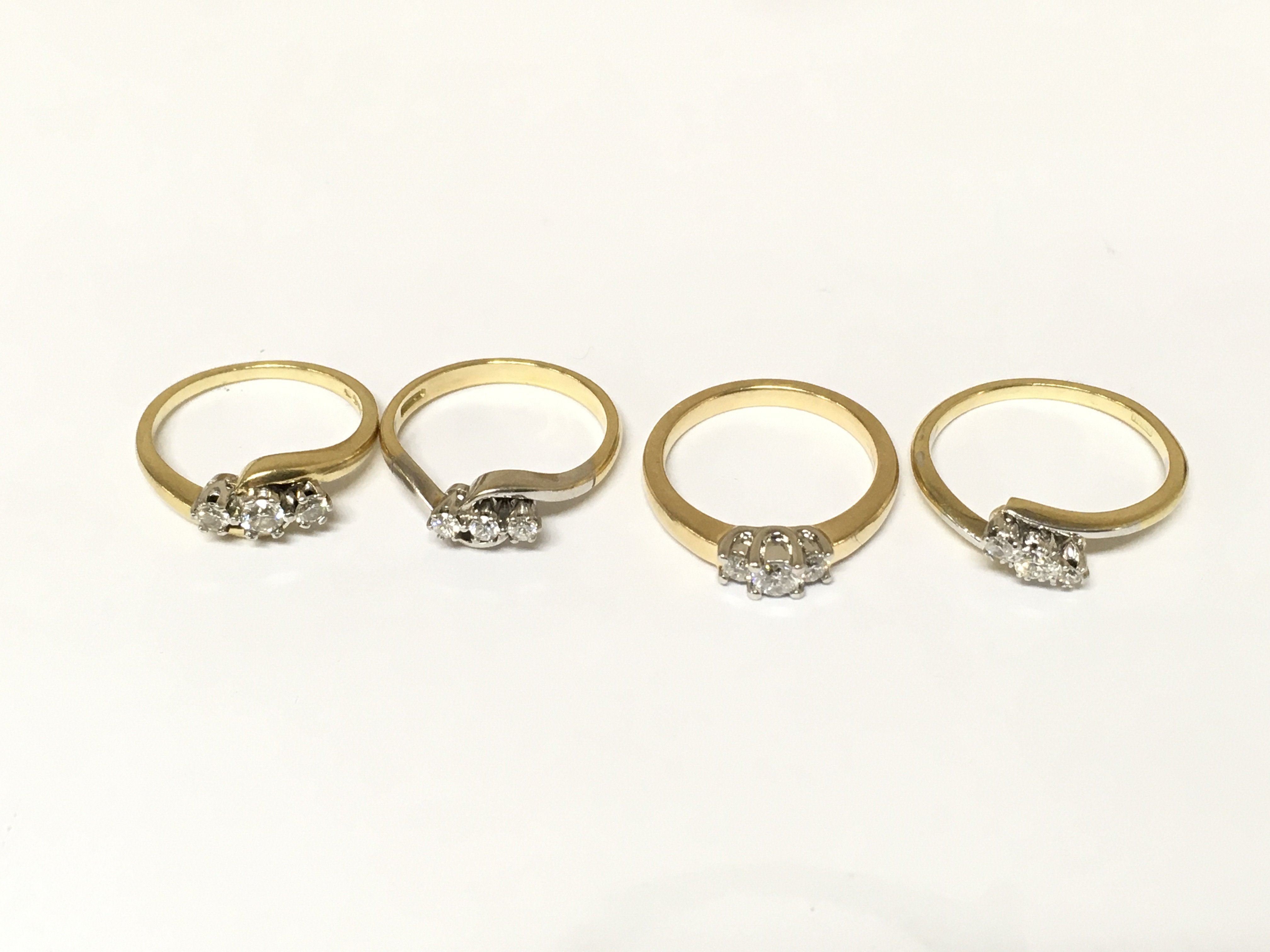Four 18ct gold 3 stone diamond rings. Approximately 13.5g and sizes J L and O
