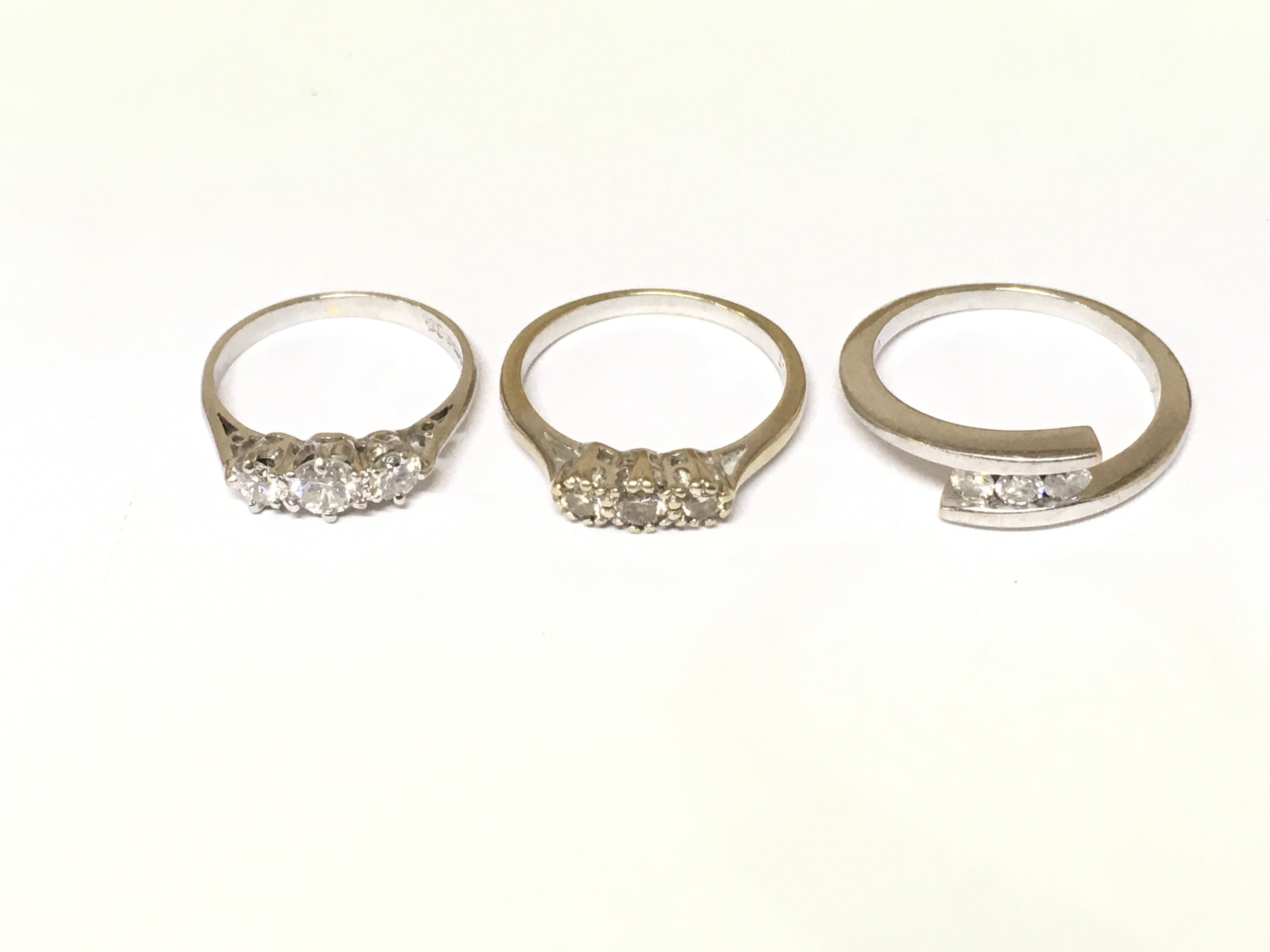 Three 18ct white gold 3 stone diamond rings. Approximately 8.2g and sizes I L and O1/2