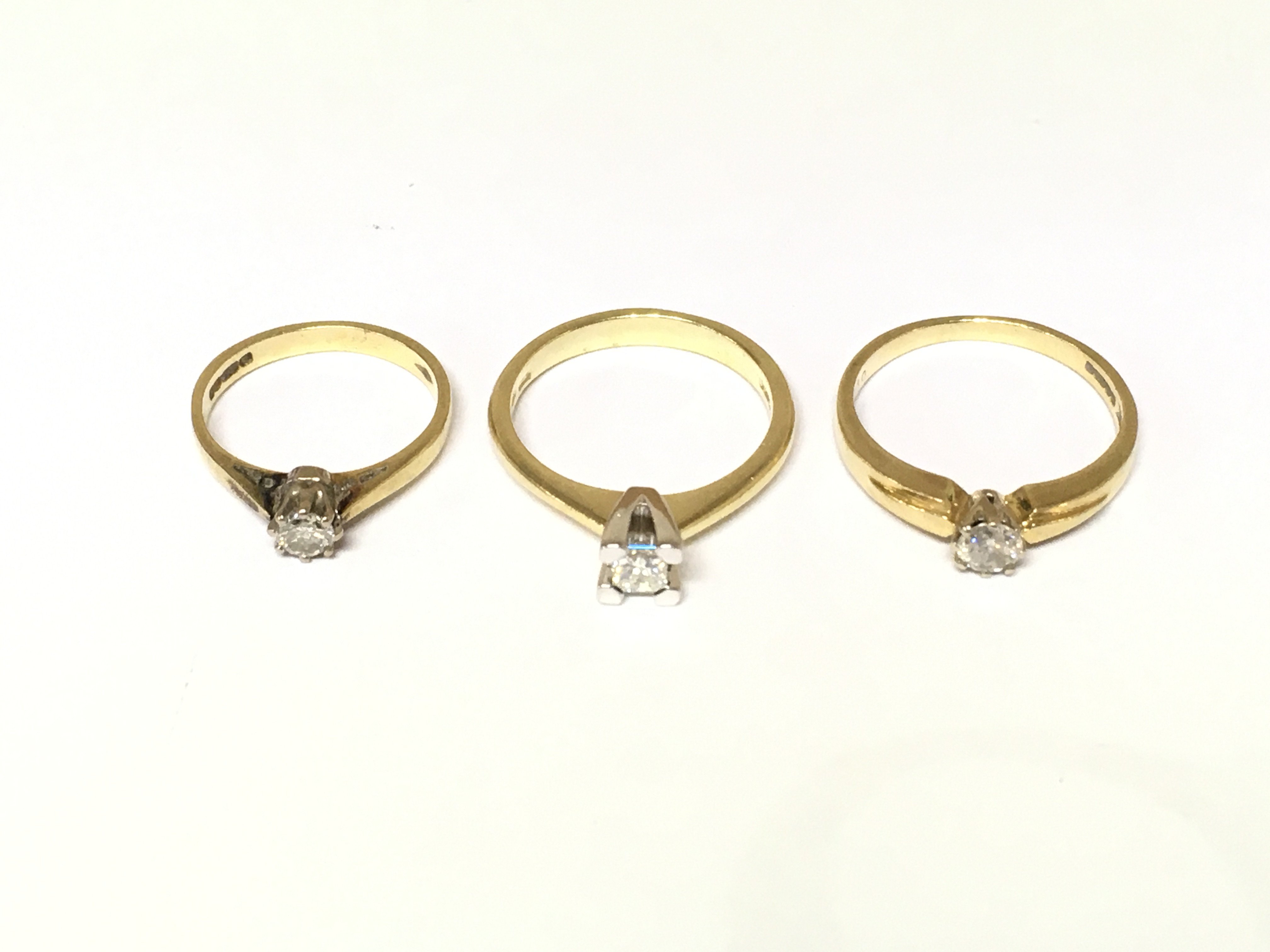 Three 18ct gold diamond solitaire rings. Approximately 9.4g and size I N1/2