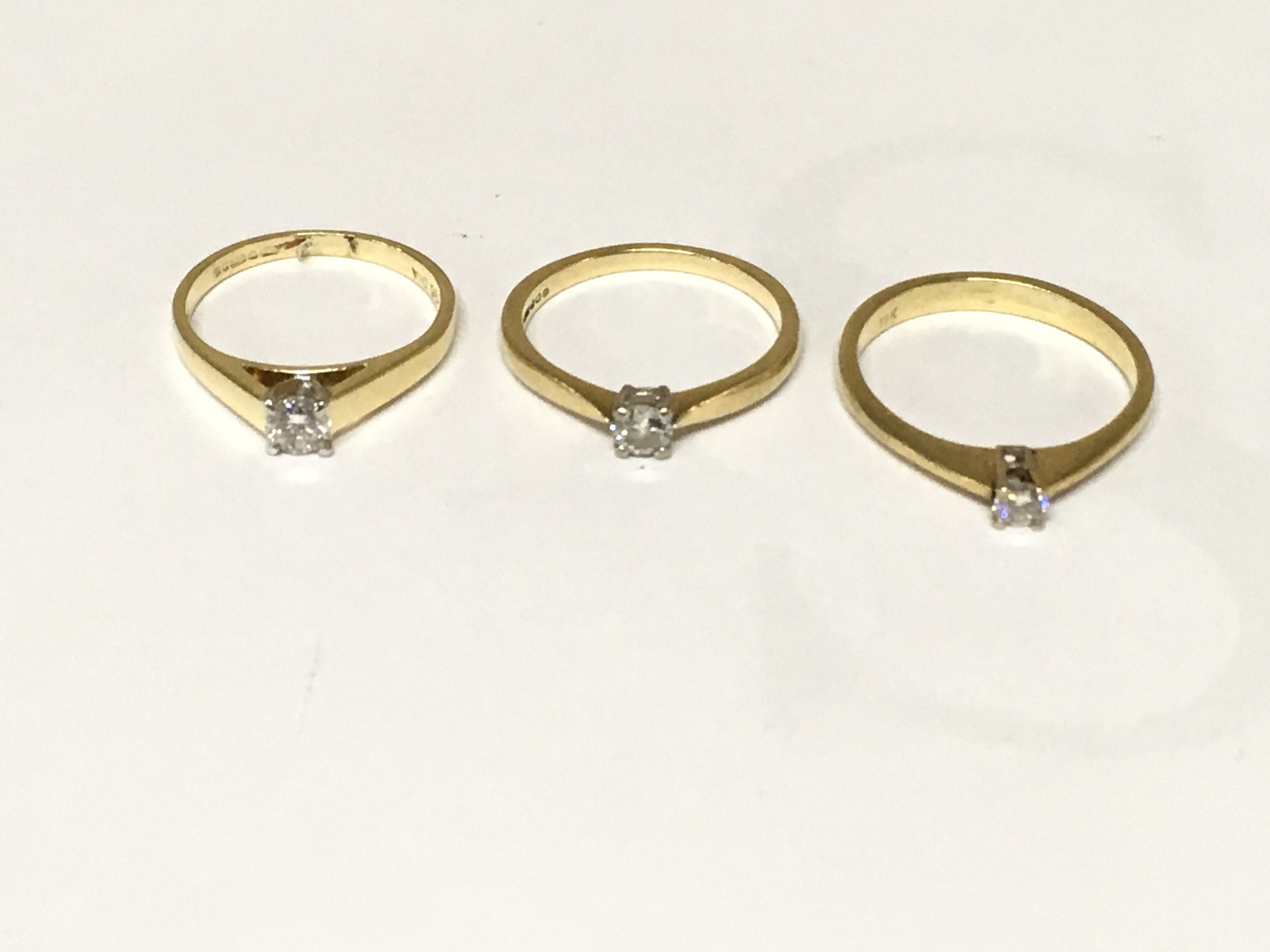 Three 18ct gold diamond solitaire rings. Approximately 7.7g and sizes L M and N