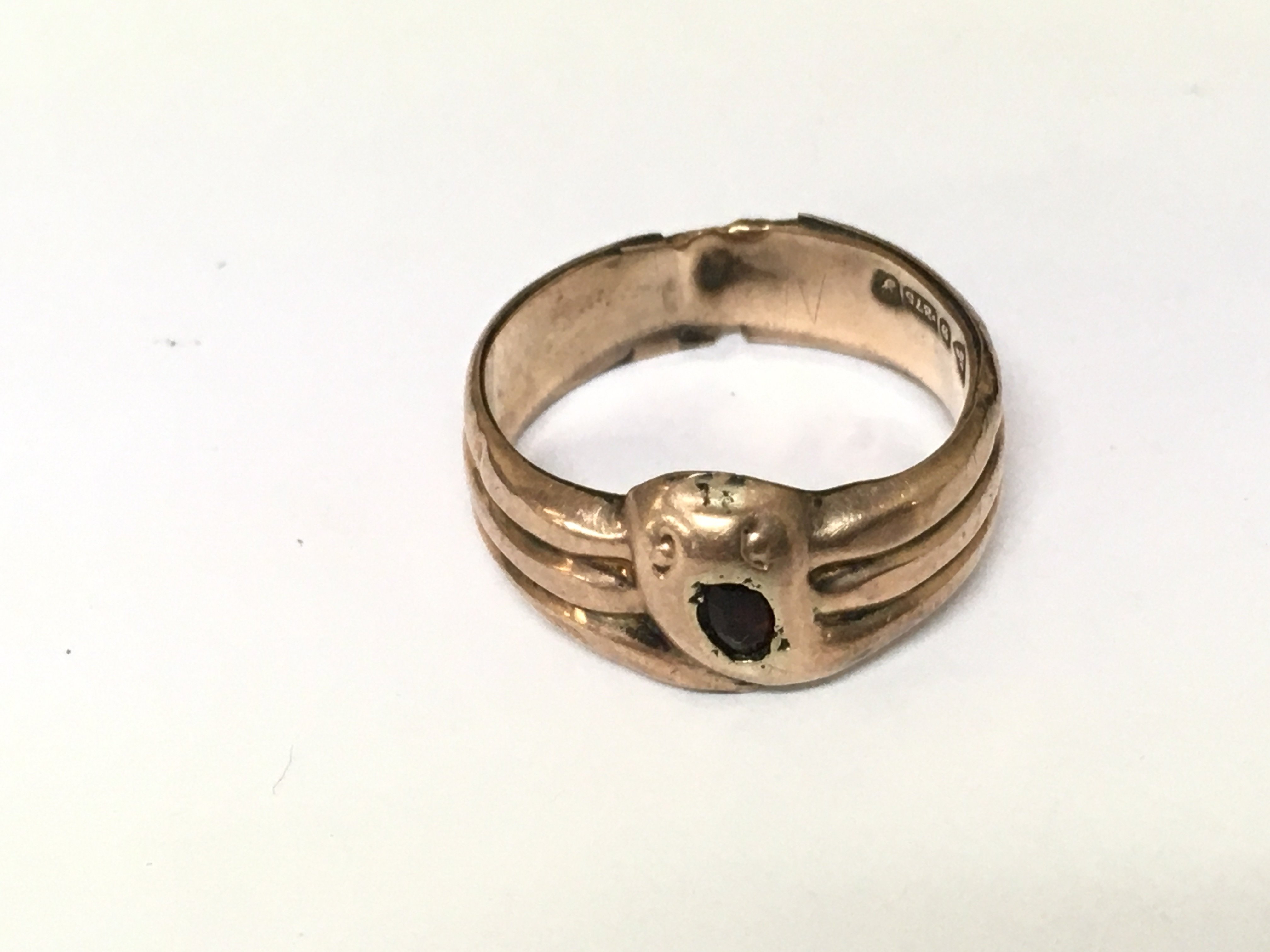 A 9ct gold ring of snake design set with a red stone. 2.75g size S