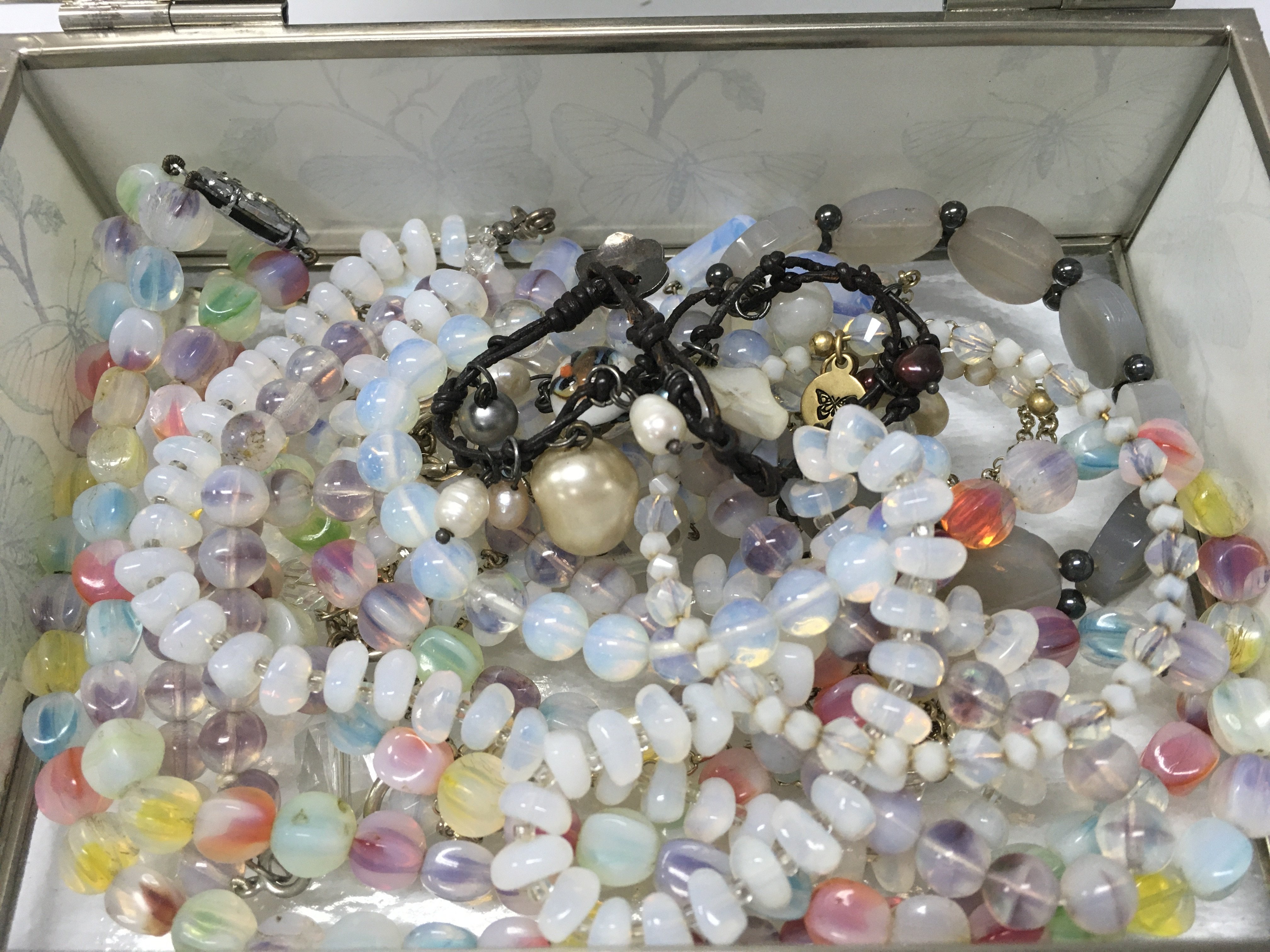 A glass butterfly box with vasilene glass necklaces
