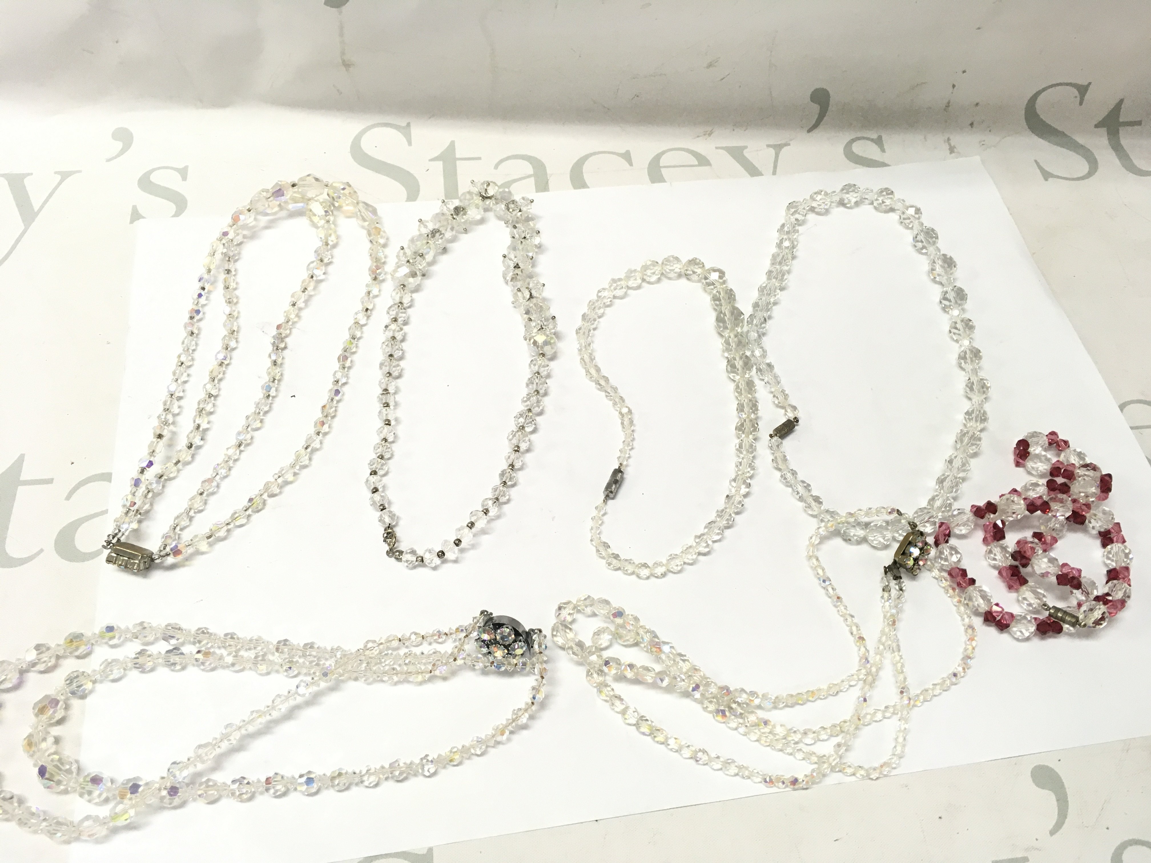 A Collection of crystal necklaces , 3 double rows 4 single rows. Postage catA