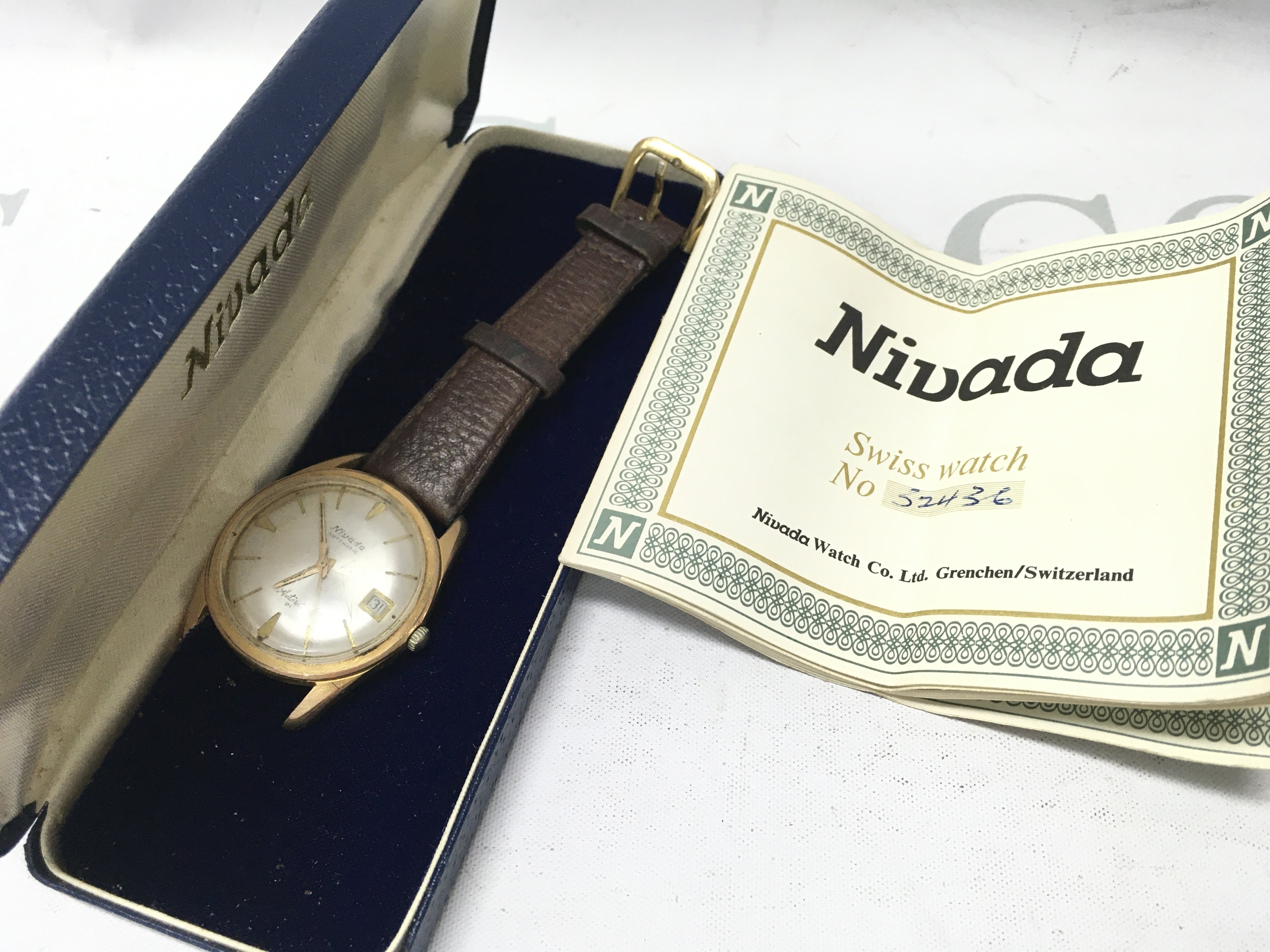 A boxed vintage gents Nivada Swiss automatic watch . Postage category A