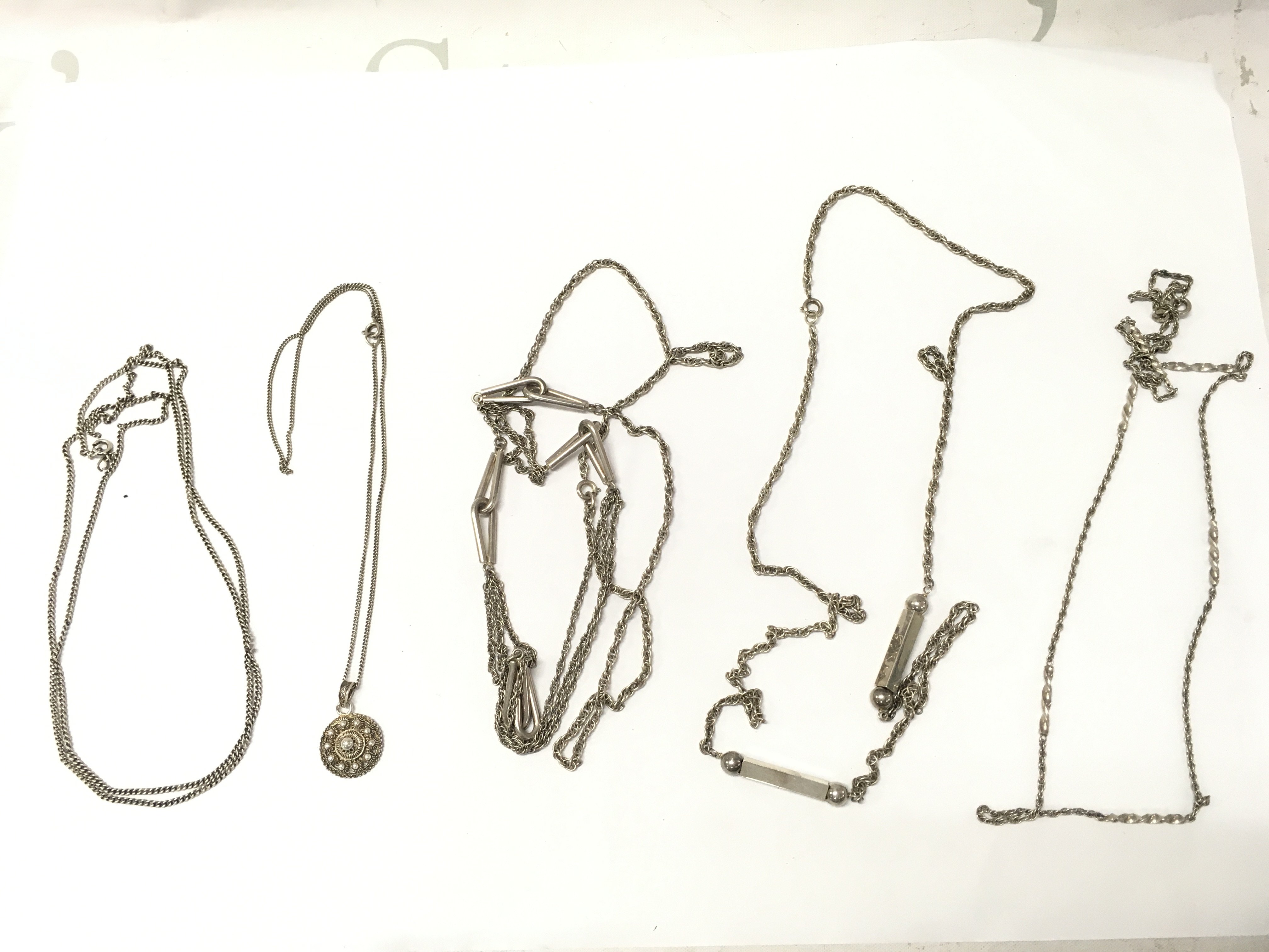 Five silver necklaces . 79g total weight Approx . Postage category A